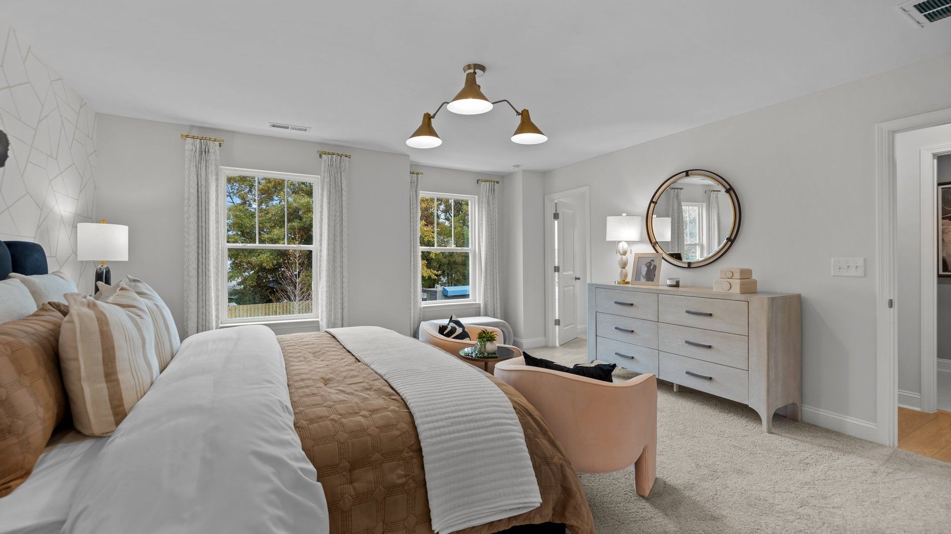 Spacious owner's suite with large windows and plush carpeting in the new Adaline Design by DRB Homes Charlotte, NC