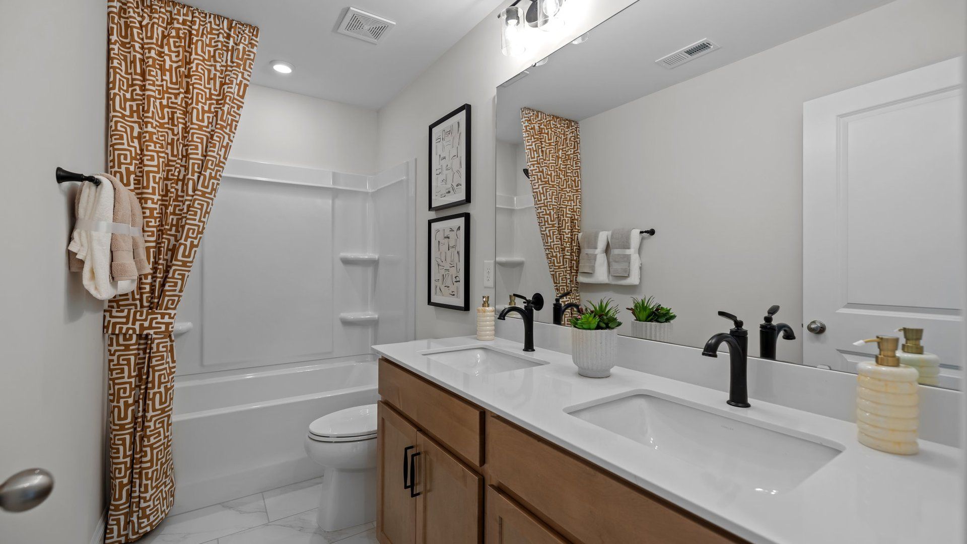 Secondary bath with soak-in tub and vanity with dual undermount sinks, in the new Adaline Design by DRB Homes Charlotte, NC