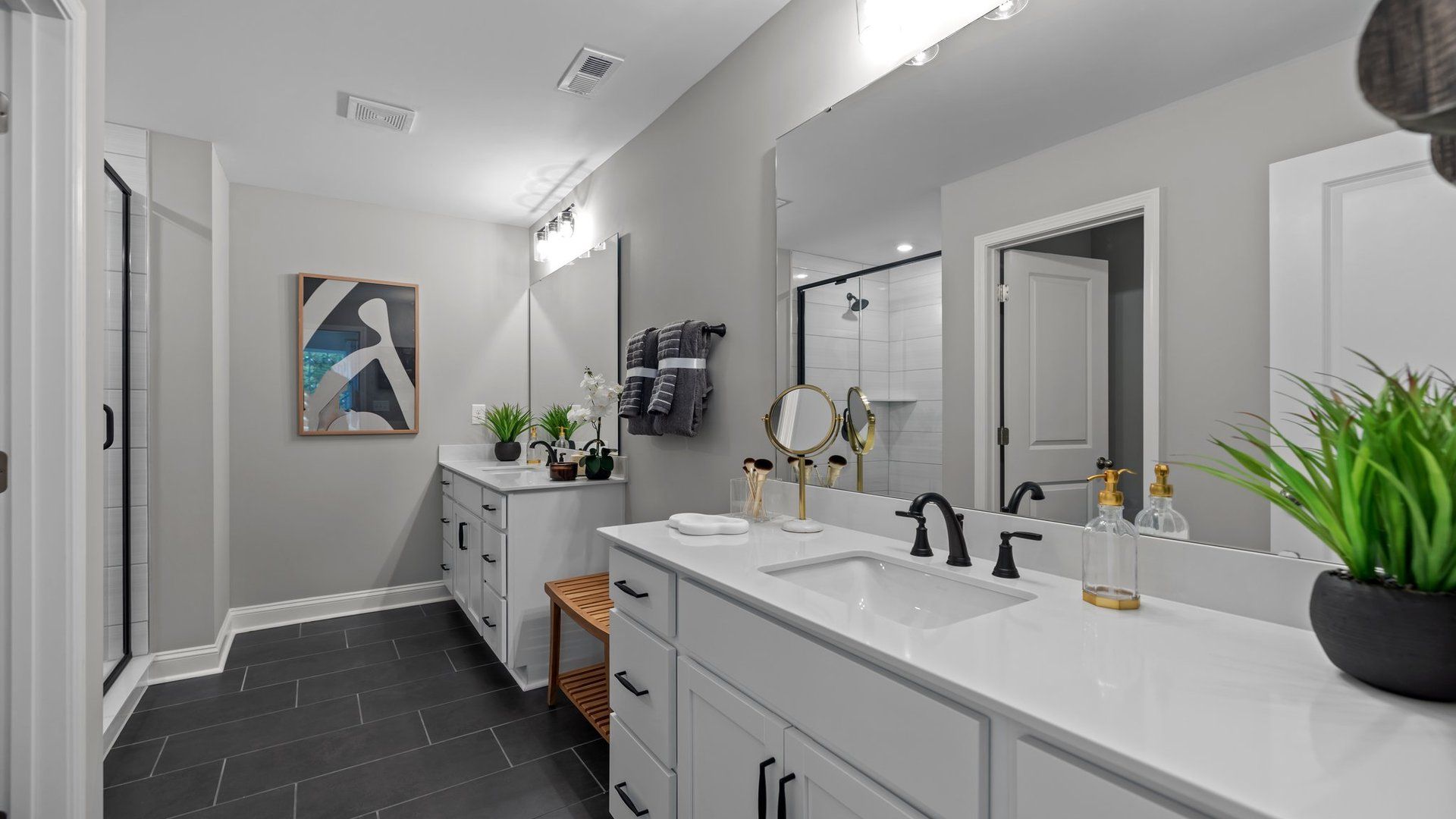 Luxurious primary bathroom with separate dual vanities and premium lighting. Greenway Overlook. DRB Homes. Charlotte, NC.