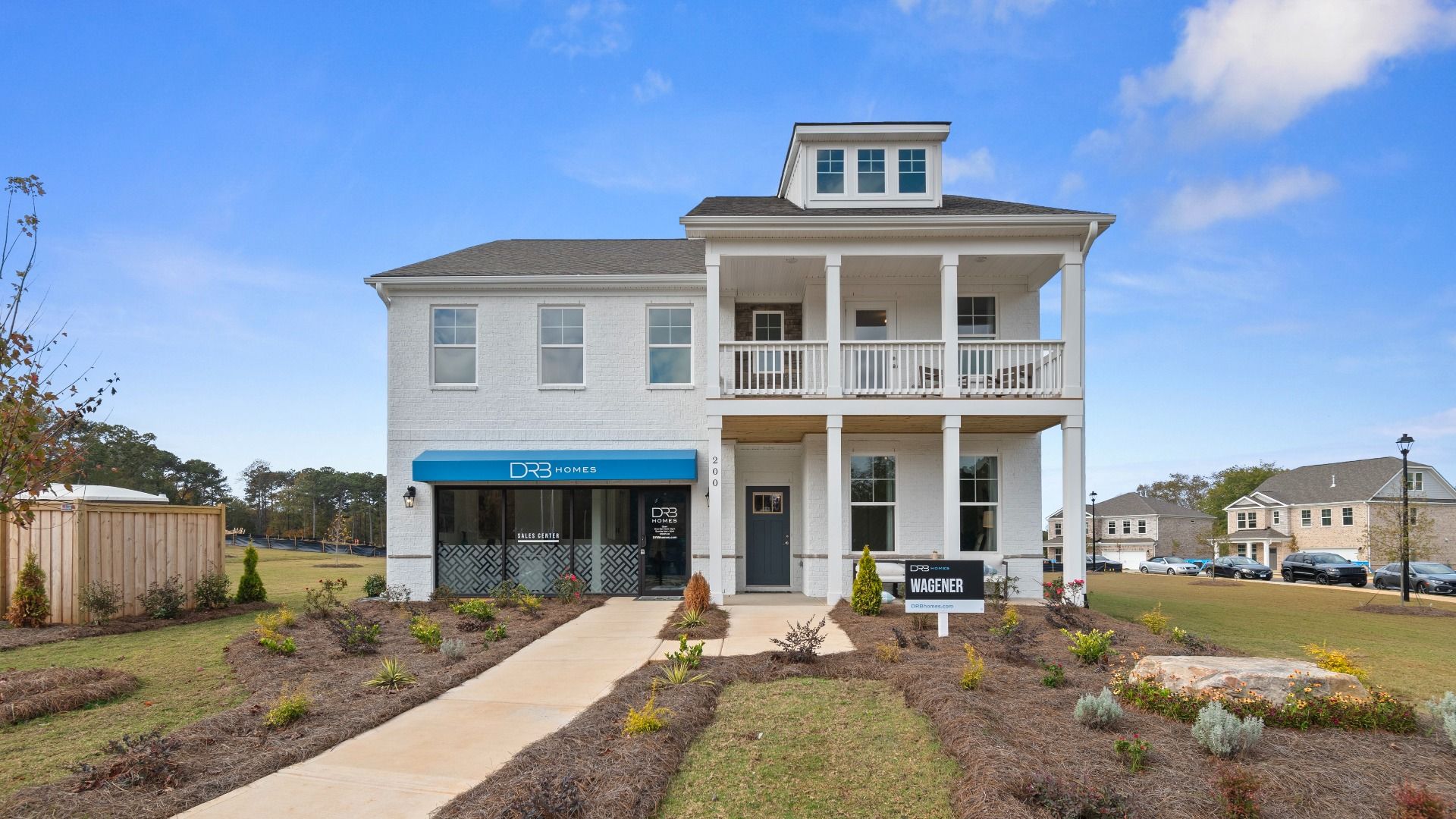 Two-story Wagener exterior with white brick, covered second-level balcony, and modern design at Burchwood in Stockbridge, GA.