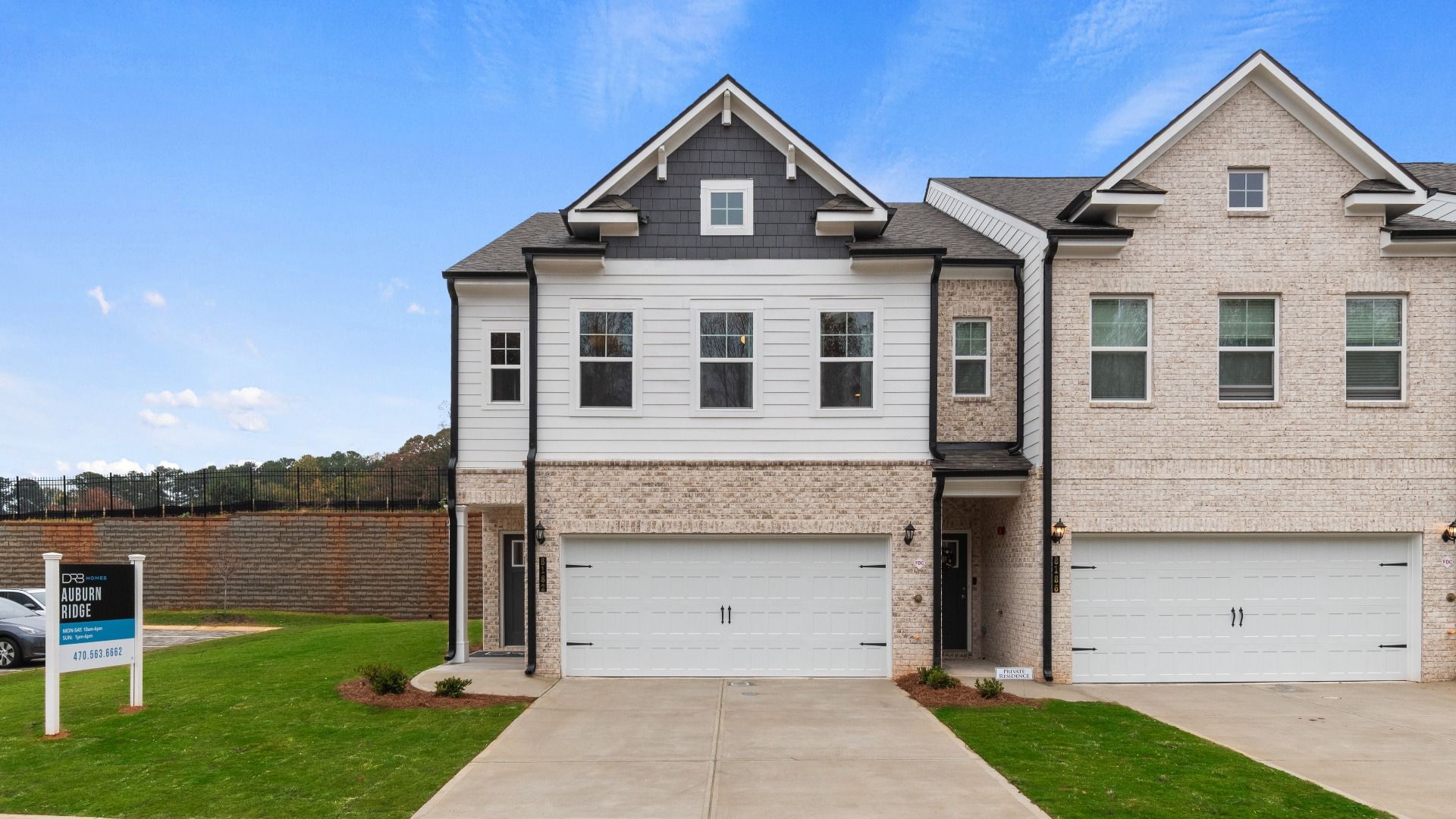 New construction townhome with James Hardie plank siding and brick detailing in townhome community in Riverdale, GA.