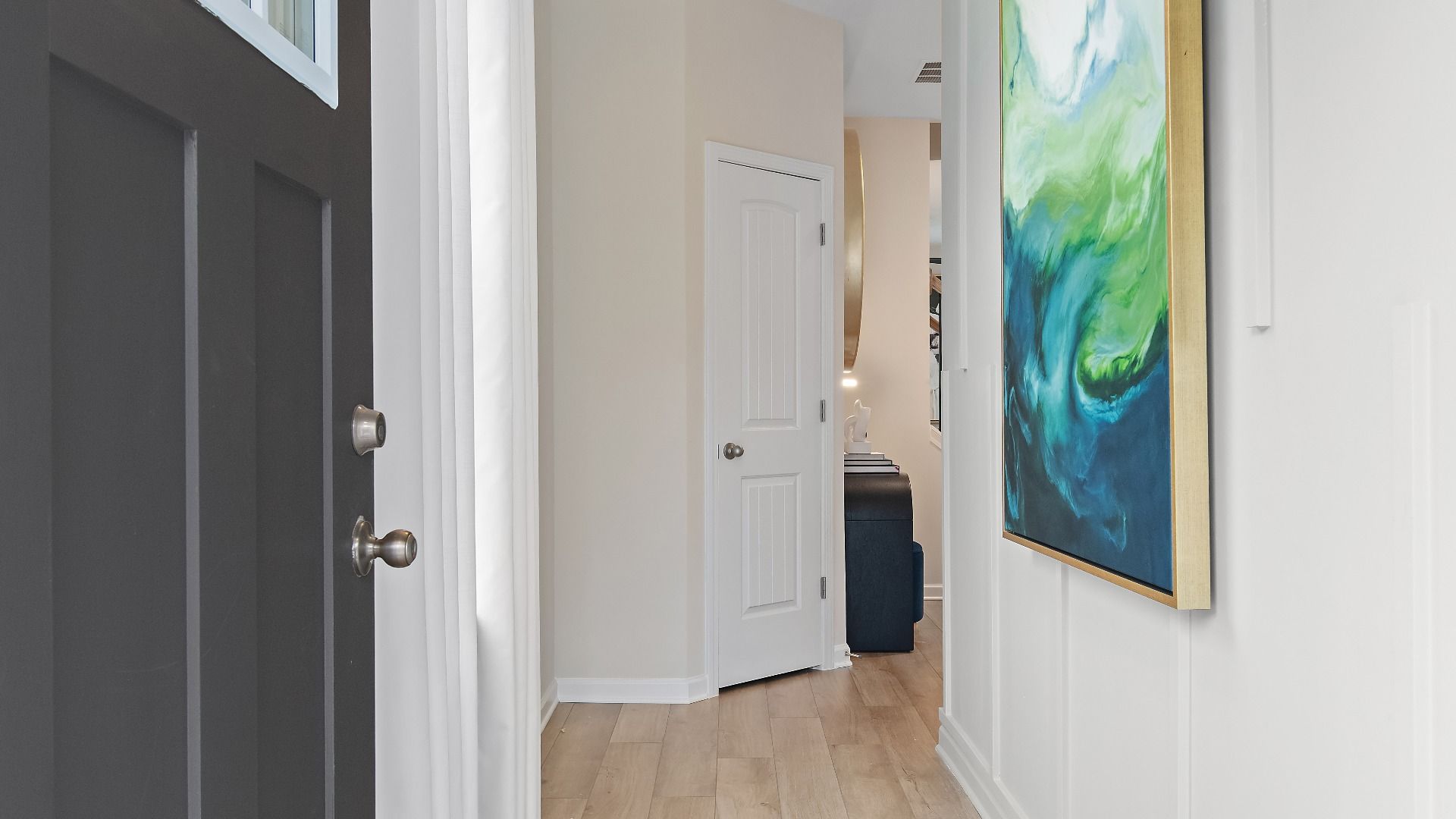 Inviting entryway of new construction townhome in Auburn Ridge featuring stylish trim and modern entry design.
