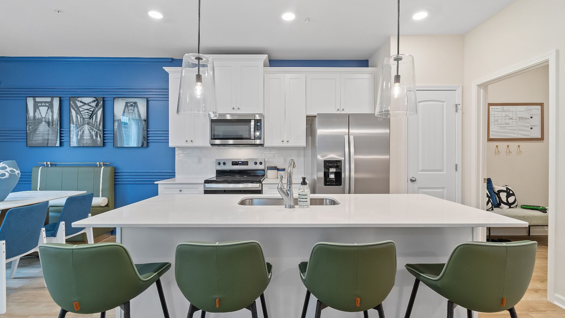 Modern kitchen with quartz island, stylish backsplash, stainless steel  appliances, and ample cabinet storage in Auburn Ridge