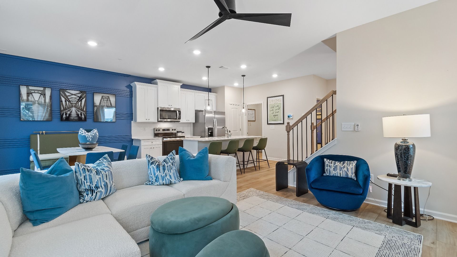 Open concept kitchen and family room in new construction townhome at Auburn Ridge with seamless flow and natural light.