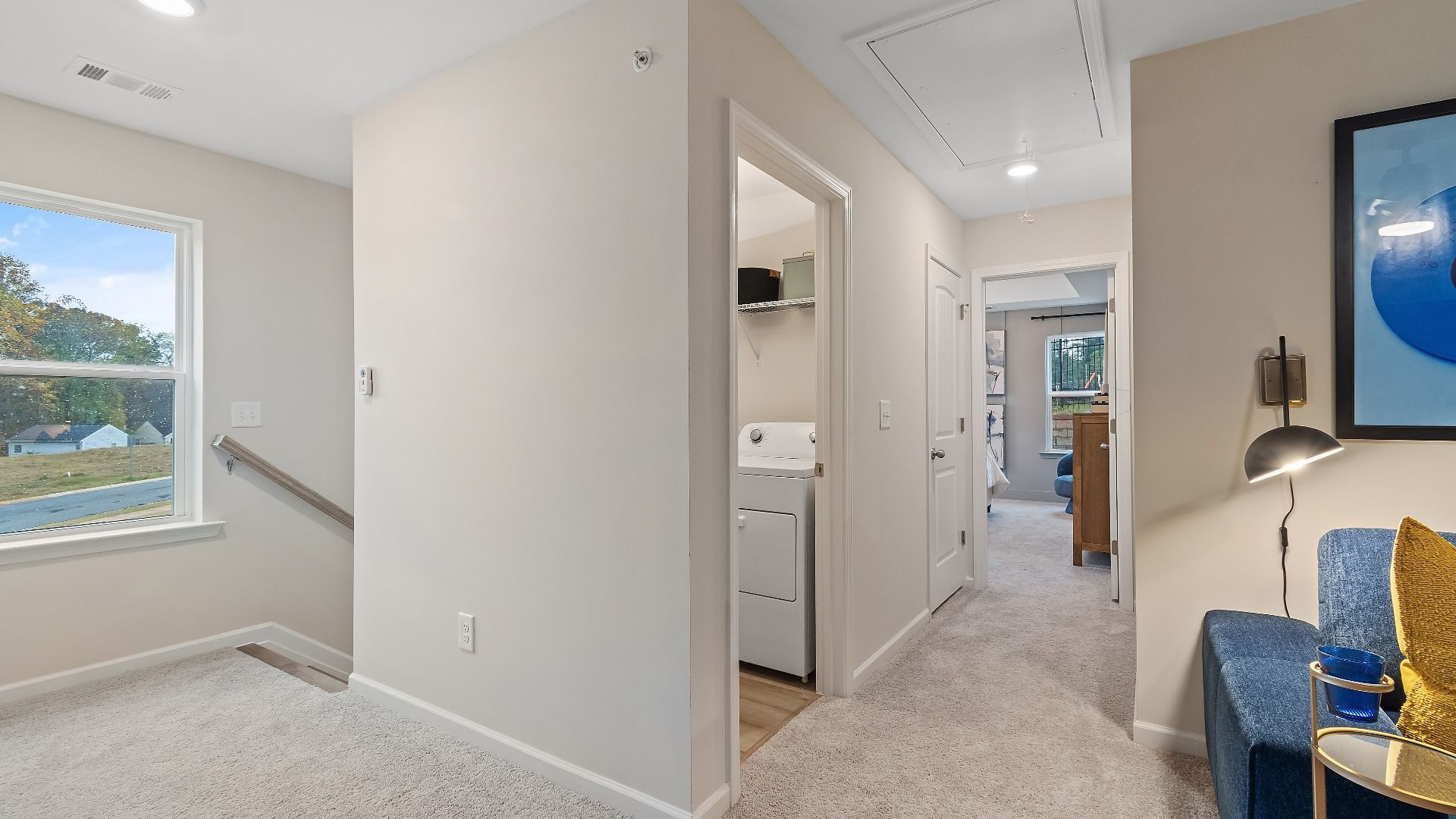 Upstairs landing with convenient laundry area and open hallway in new construction townhome at Auburn Ridge in Riverdale, GA.