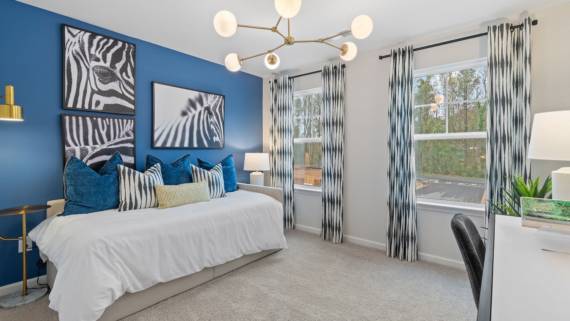 Comfortable secondary bedroom with modern design and bright window in Auburn Ridge townhome in Riverdale, GA.