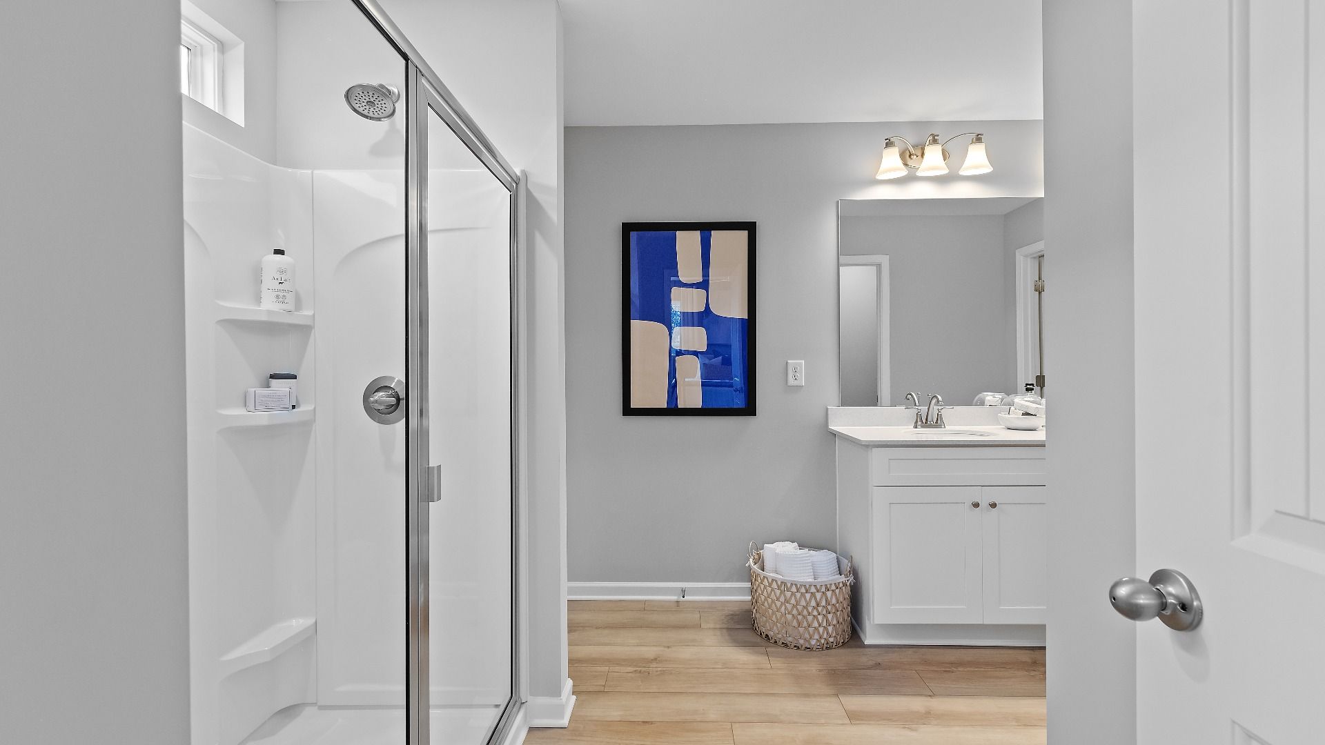 Bright bathroom featuring modern design, quartz vanity tops, sleek finishes, and ample lighting in new townhome.