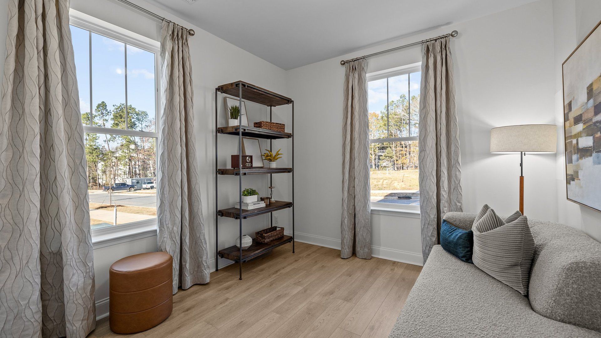 Versatile bedroom on the main level with elevated ceiling and large windows in The Landon Design by DRB Homes, Charlotte, NC
