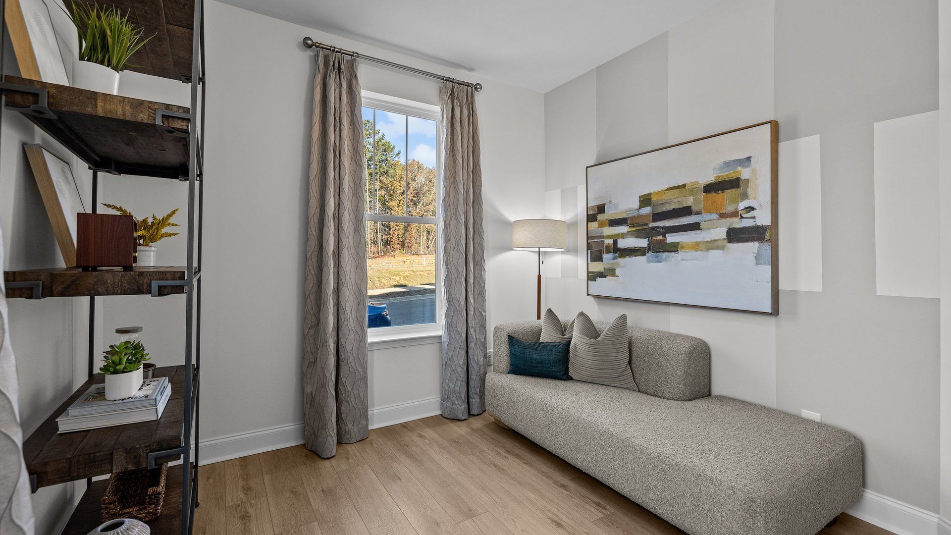 Versatile bedroom on the main level with elevated ceiling and large windows in The Landon Design by DRB Homes, Charlotte, NC