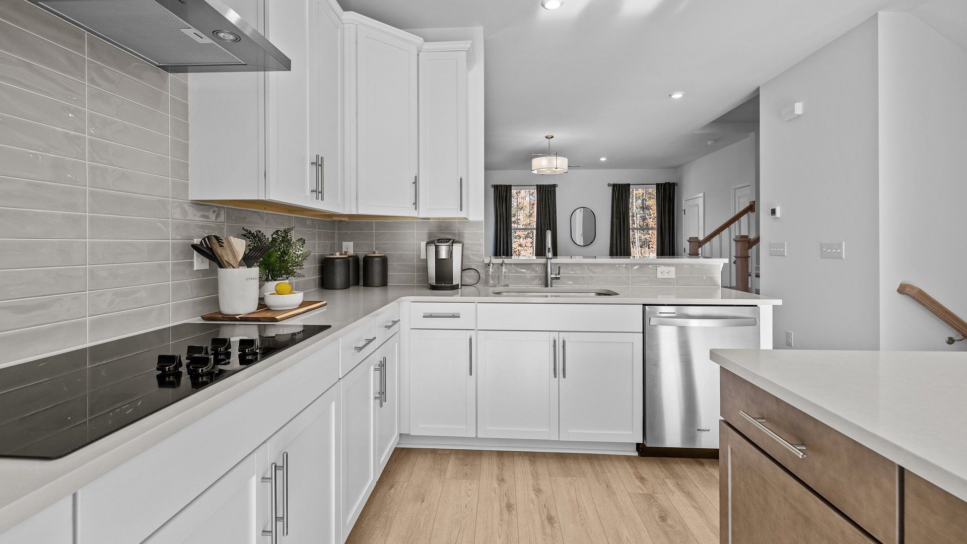 Gourmet kitchen with 36" electric cooktop, 42" upper cabinets, and quartz counter tops, in The Landon Design by DRB Homes