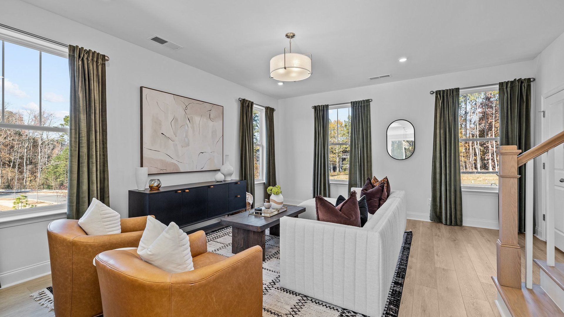Bright family room with elevated ceiling and large windows, in The Landon Design by DRB Homes Charlotte, NC