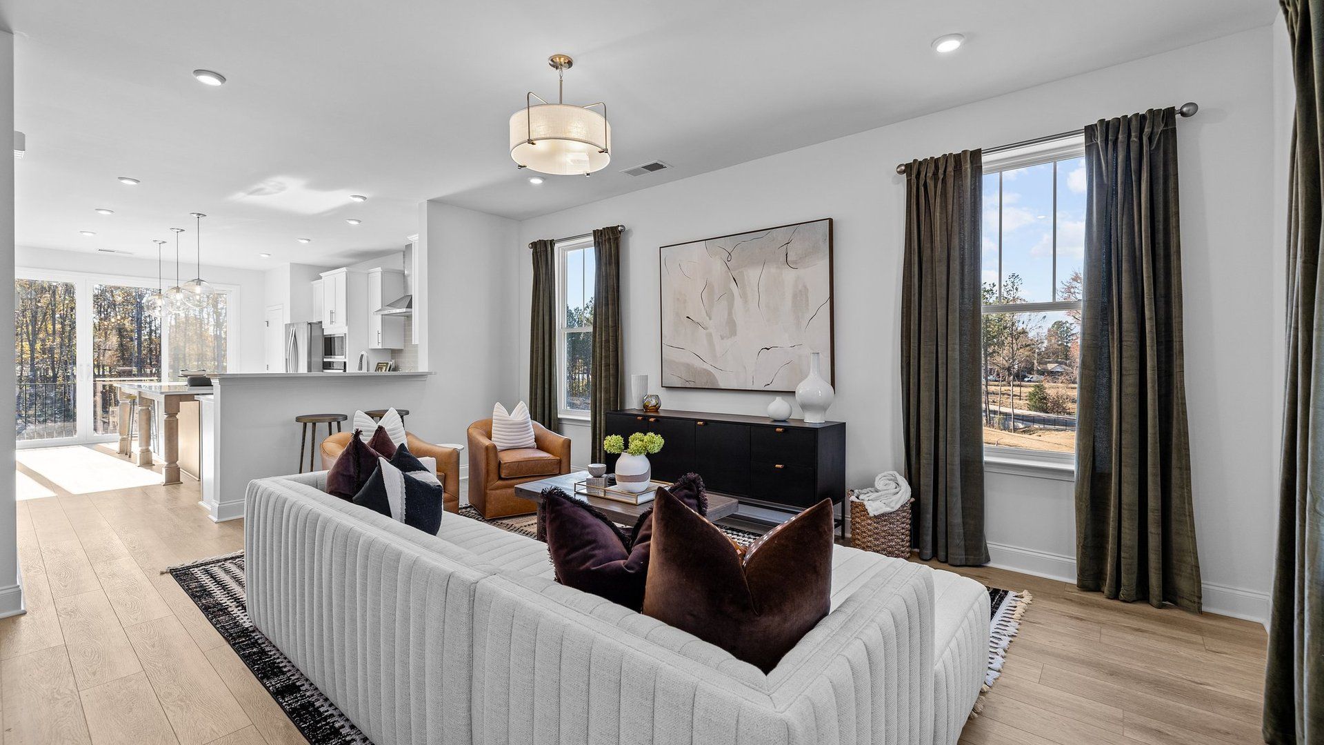 Open concept family room, gourmet kitchen, large windows, and elevated ceiling in the Landon Plan by DRB Homes Charlotte, NC