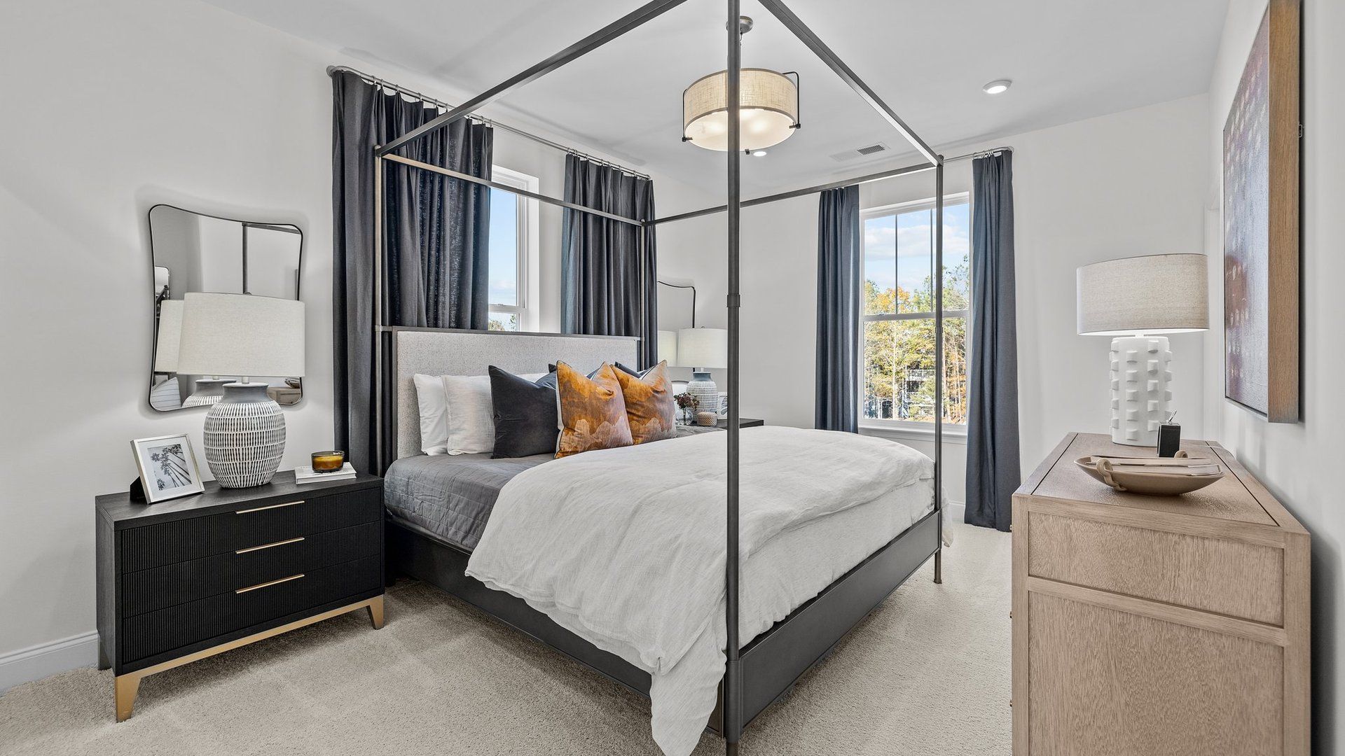 Luxurious secondary bedroom with elevated ceiling and large windows in the Landon Design by DRB Homes Charlotte