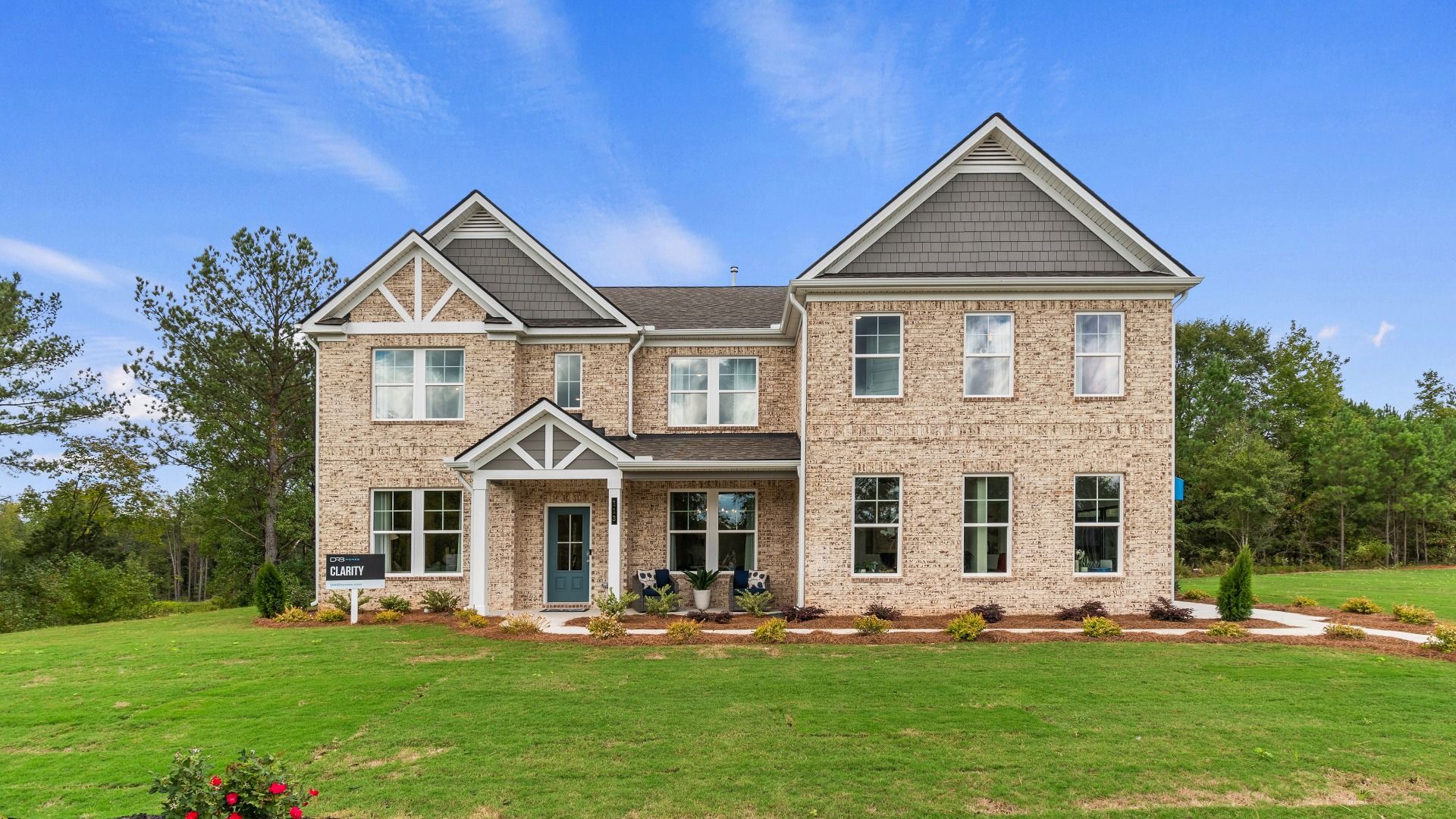 Clarity 4-sided brick new construction single family home with covered front porch and side-entry garage at Trinity Park.