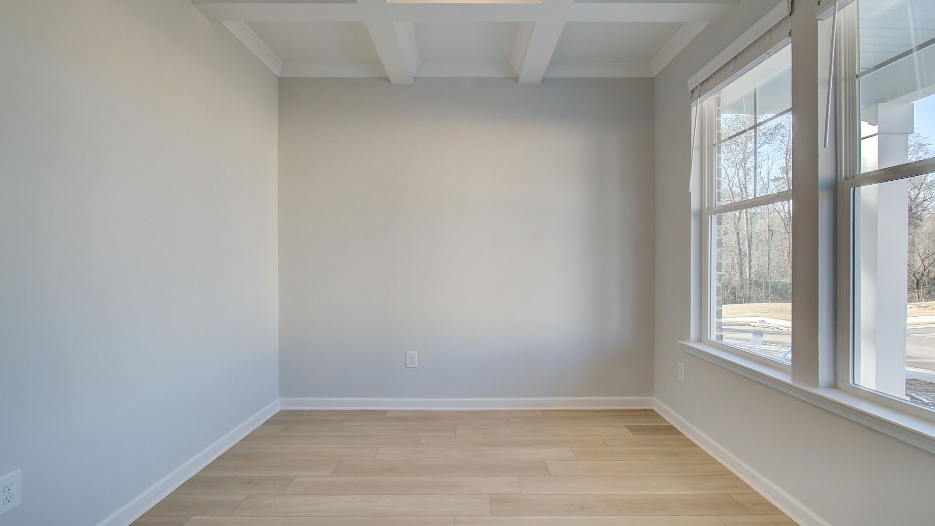 Pelham dining room with coffered ceiling and natural light at new construction Bowers Farm in McDonough, GA.