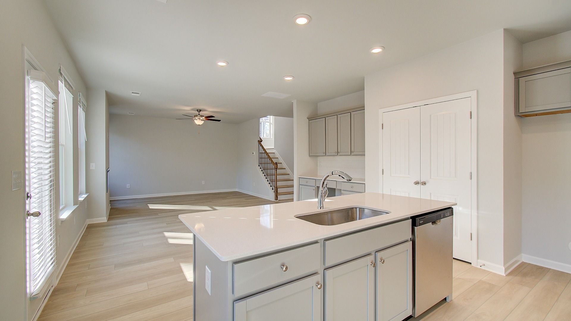 Open-concept Pelham kitchen with abundant cabinetry, center island, and neutral modern finishes at Bowers Farm McDonough, GA.
