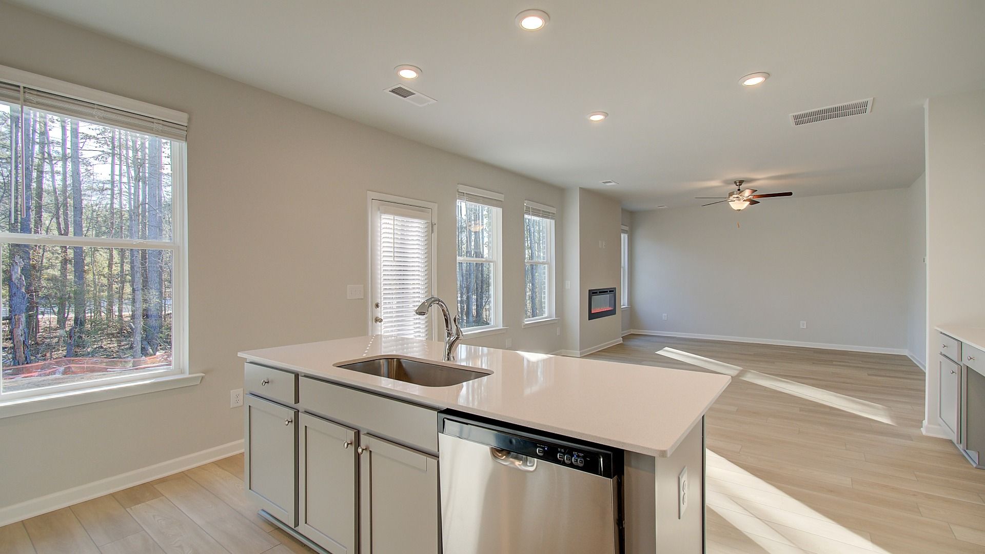 Open-concept Pelham kitchen with center island, natural light, and neutral modern finishes at Bowers Farm McDonough, GA.