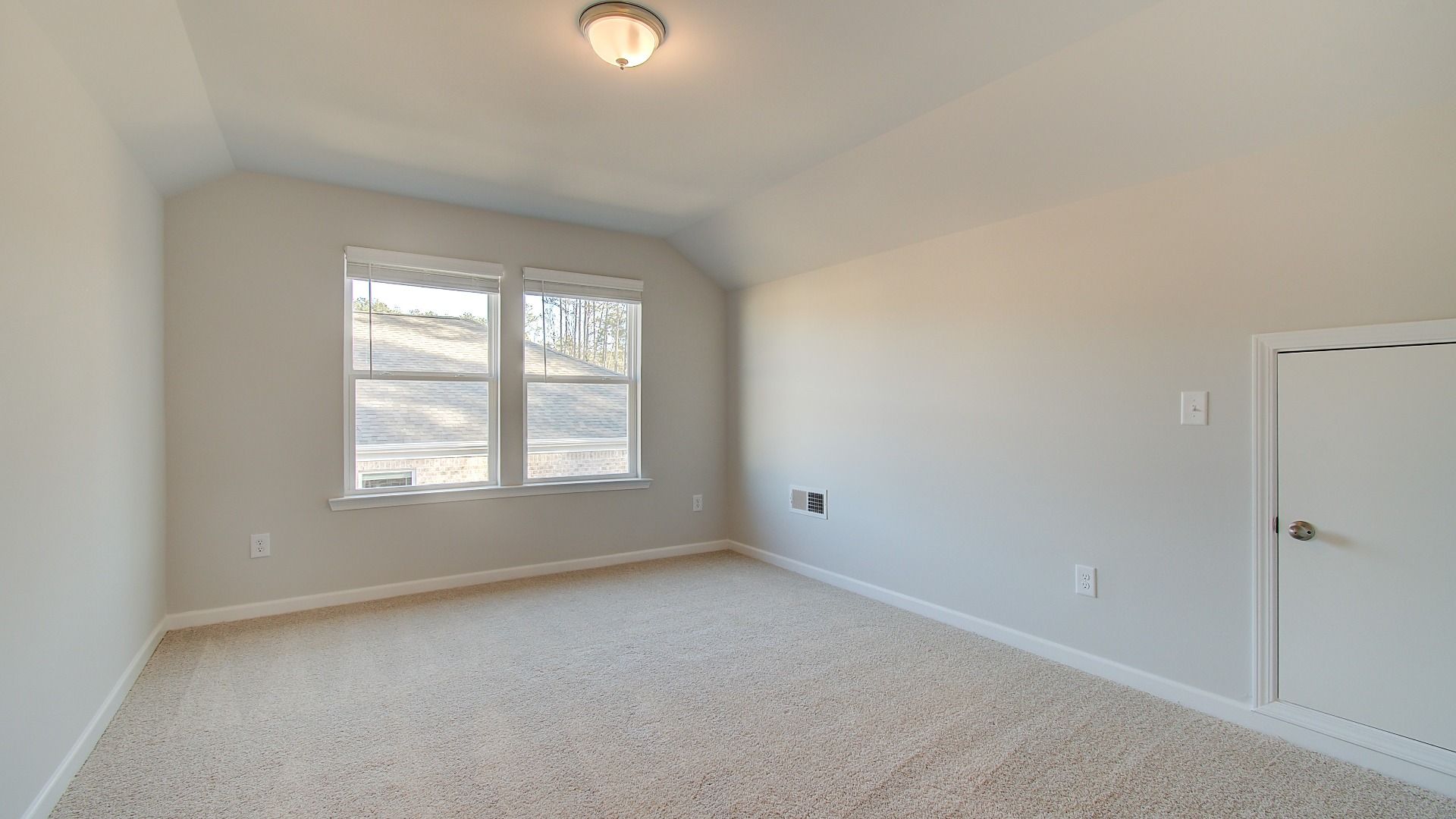 Spacious second level bonus room for flexible use with natural light and carpet flooring in the Pelham at Bowers Farm.