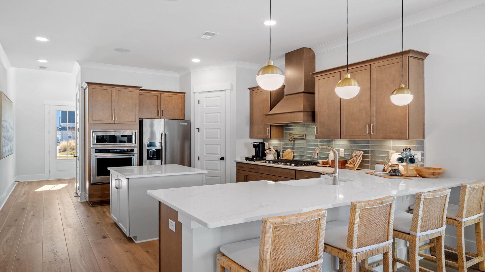 Gourmet kitchen with farmhouse sink- Model Home in Midtown at Nexton in by DRB homes offering an open layout