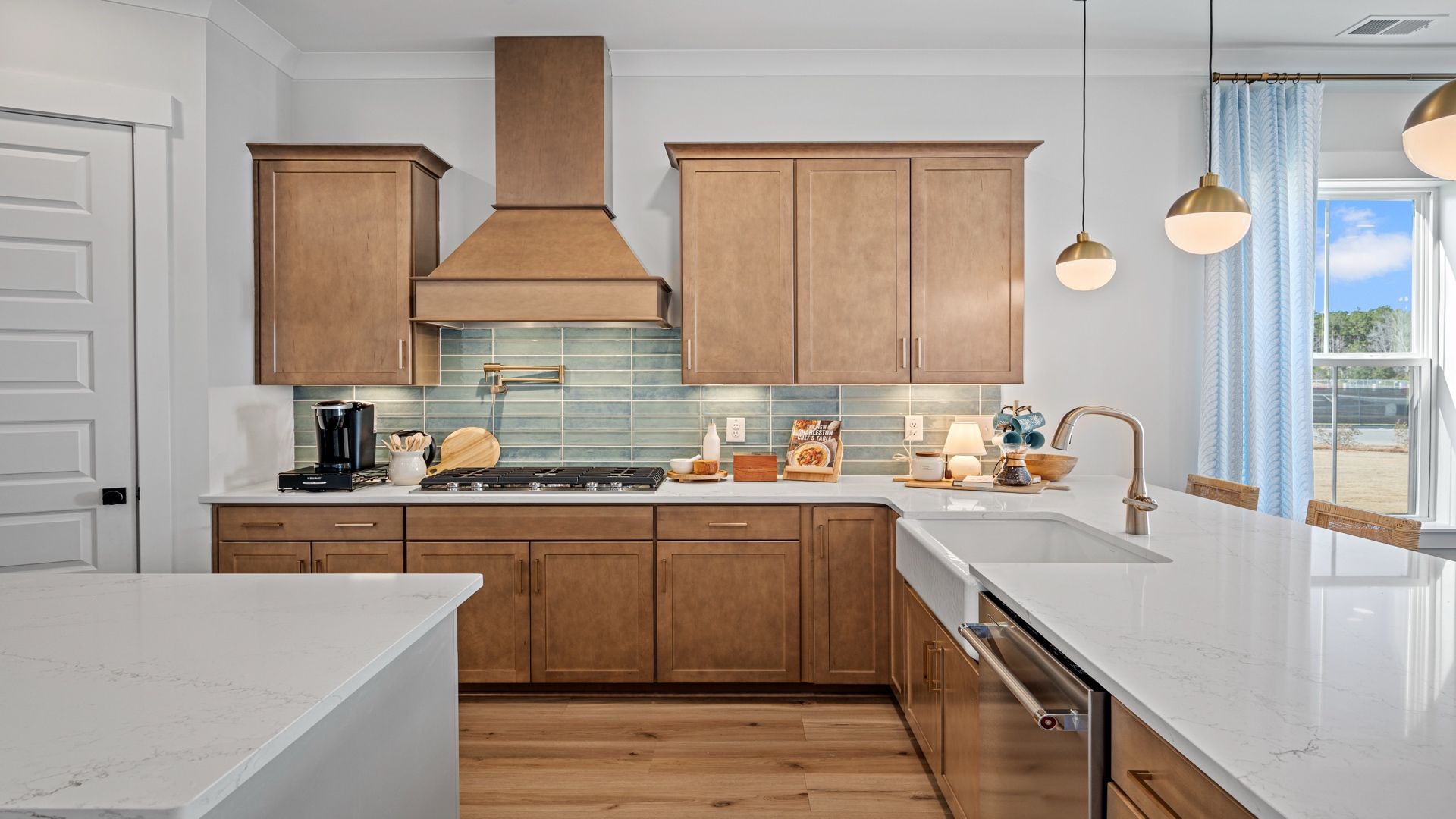 Gourmet kitchen with farmhouse sink- Model Home in Midtown at Nexton in by DRB homes offering an open layout