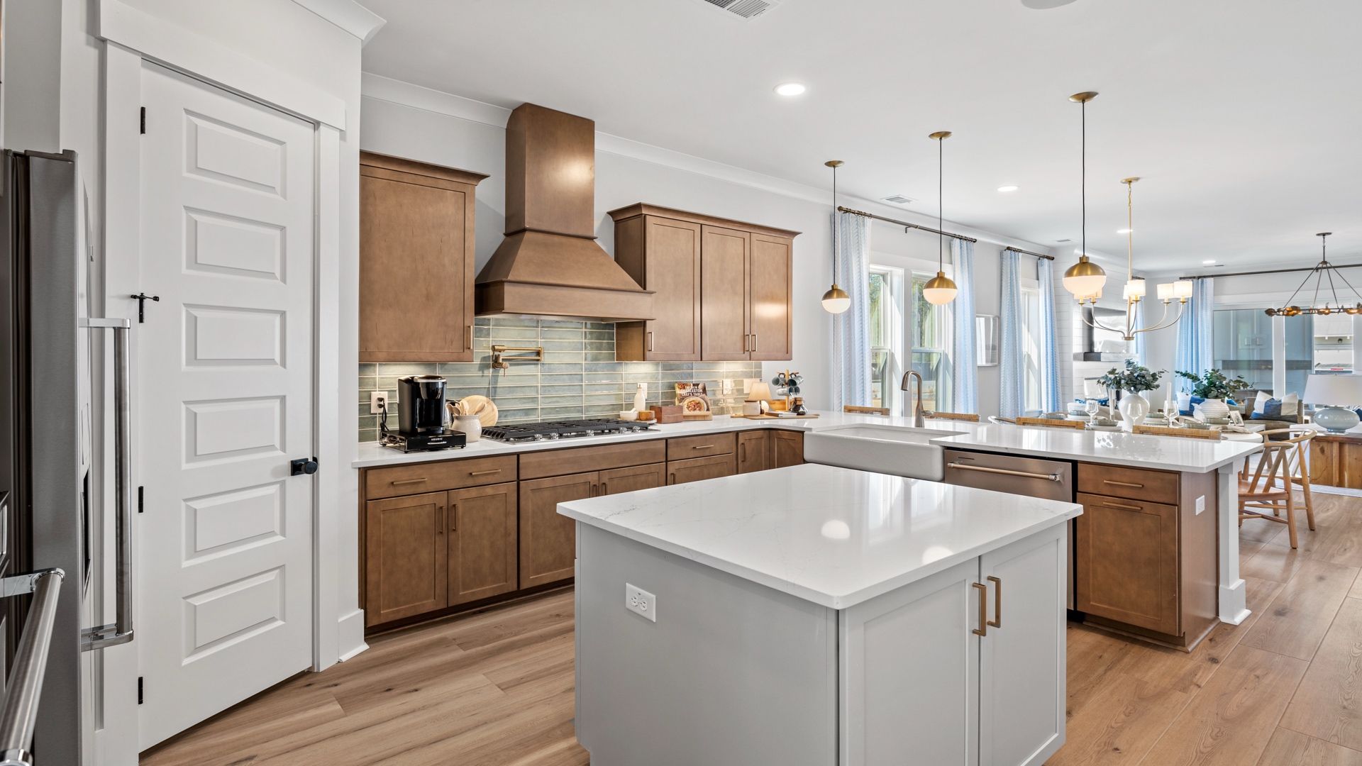 Gourmet kitchen with farmhouse sink- Model Home in Midtown at Nexton in by DRB homes offering an open layout
