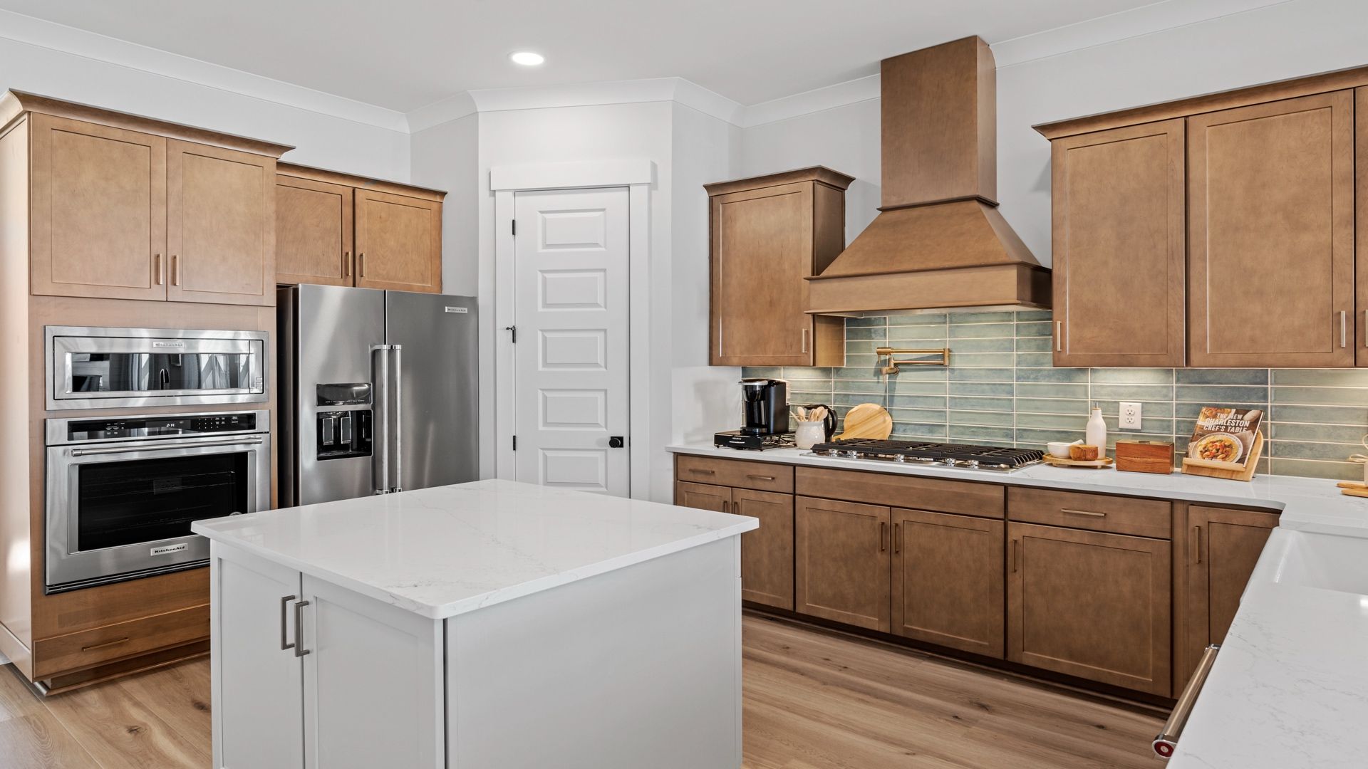 Gourmet kitchen with farmhouse sink- Model Home in Midtown at Nexton in by DRB homes offering an open layout