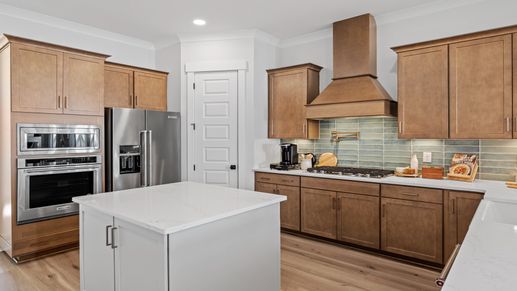 Gourmet kitchen with farmhouse sink- Model Home in Midtown at Nexton in by DRB homes offering an open layout