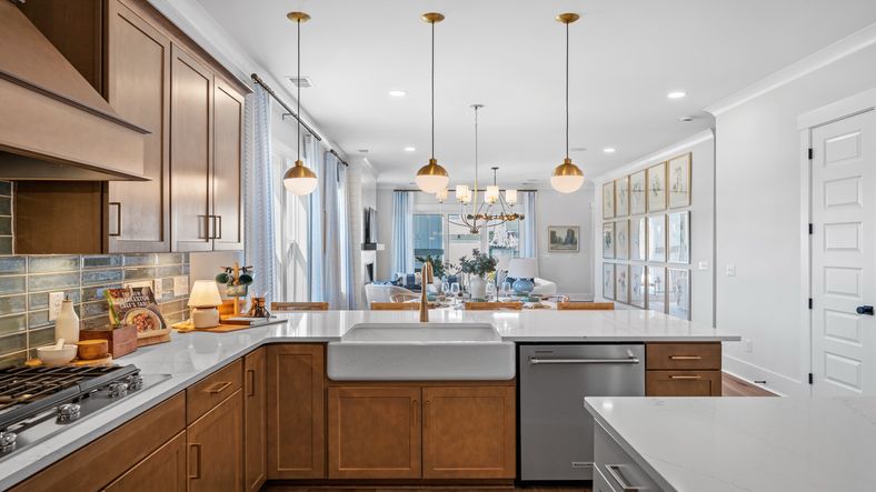 Gourmet kitchen with farmhouse sink- Model Home in Midtown at Nexton in by DRB homes offering an open layout