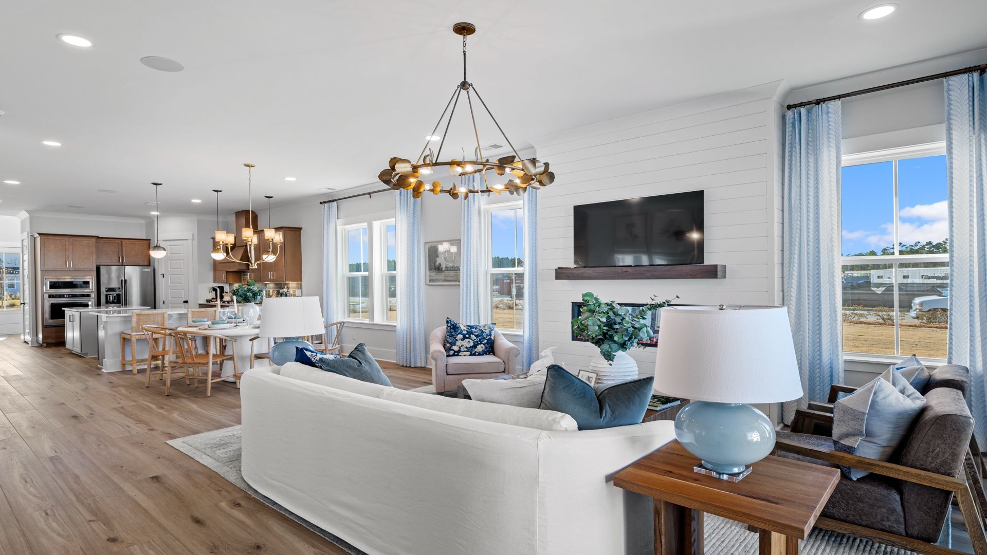 Living Room and Kitchen - Beaufain Model Home in Midtown at Nexton in by DRB homes offering an open layout