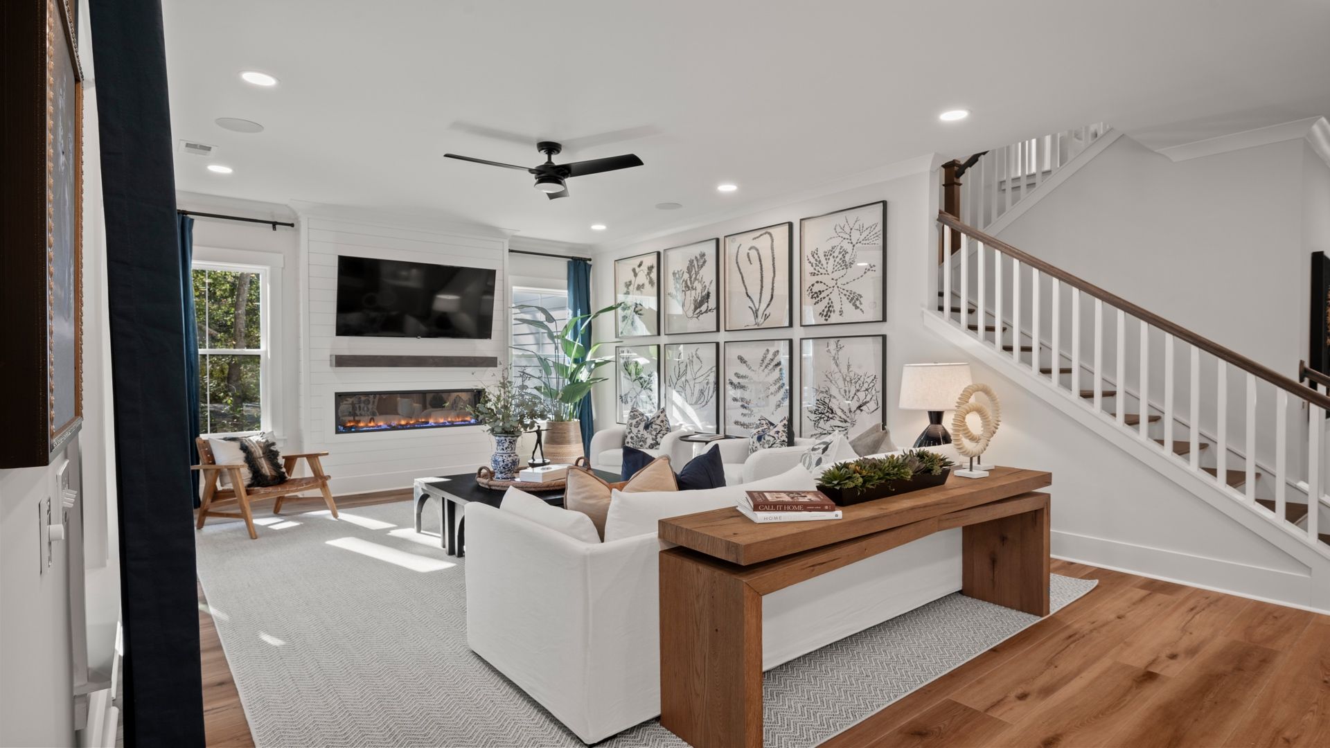 Living Room- at Pamlico Terrace at by DRB Homes features an open layout with an electric fireplace