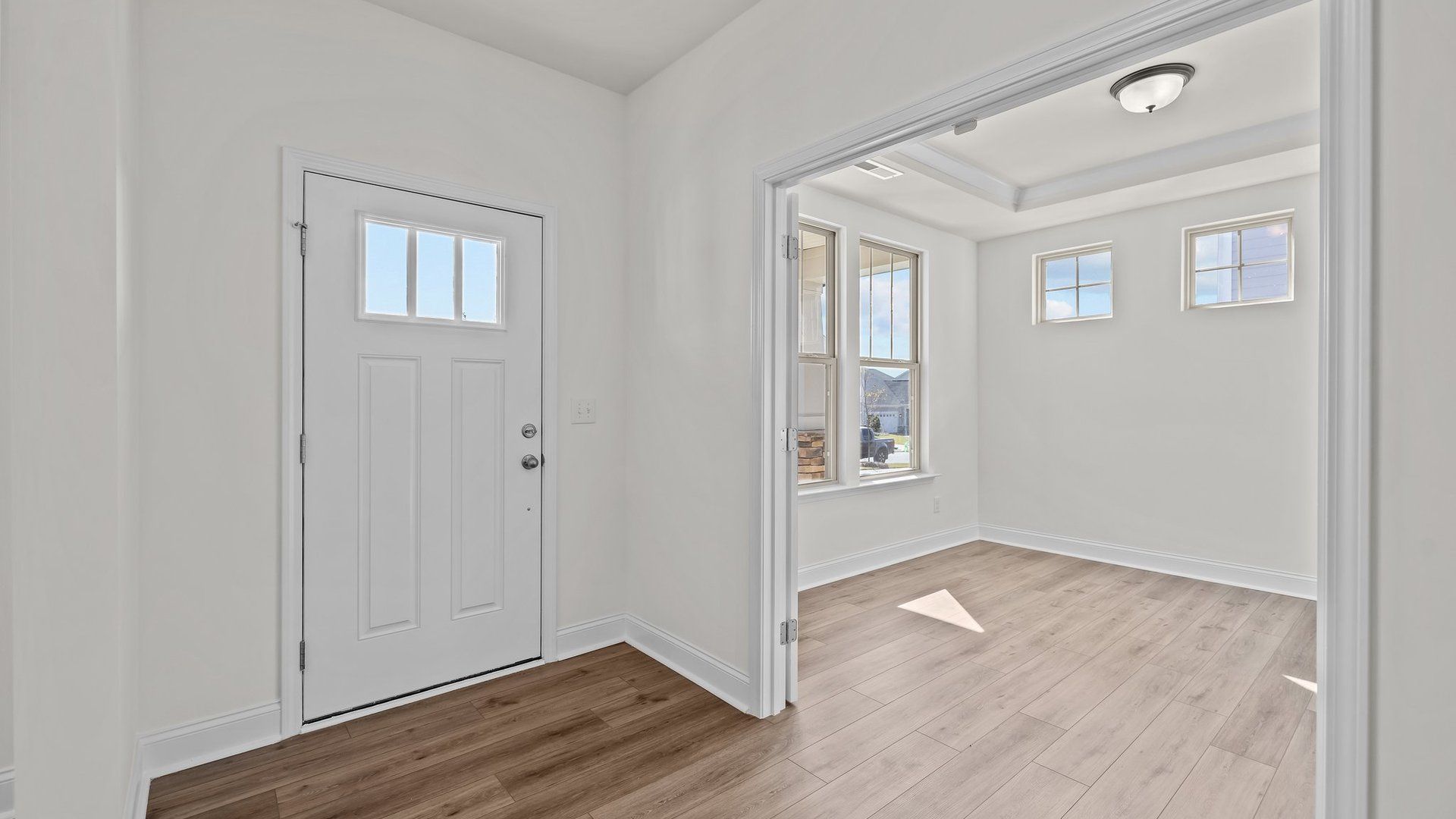 Norris Design inviting wide-entry front door and study with raised tray ceiling. At Lakeside Glen by DRB Homes in York, SC.