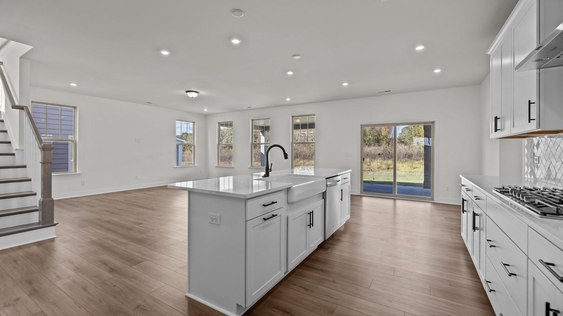 Norris Design gourmet kitchen island and convenient open concept. At Lakeside Glen by premier builder DRB Homes in York, SC.