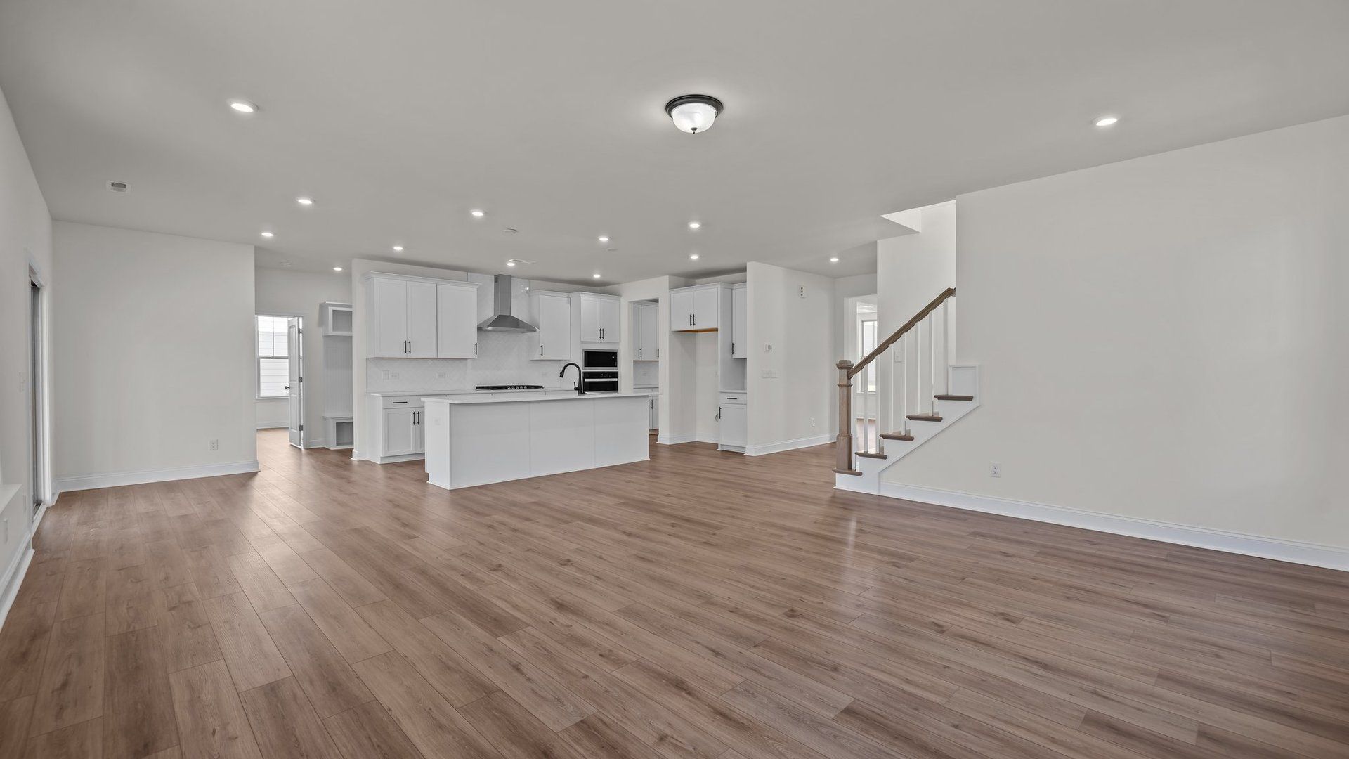 Open Concept family room and gourmet kitchen with elevated ceiling in the Norris Design by DRB Homes in York, SC