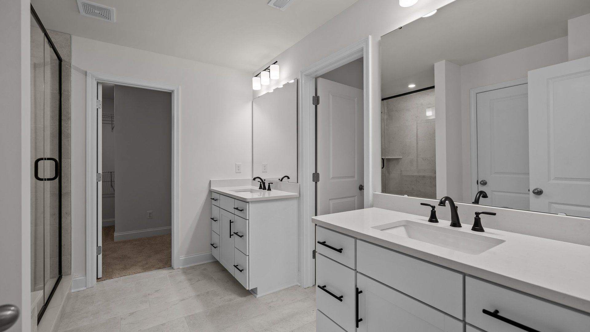 Norris Design primary bathroom with separate vanities and premium finishes. At Lakeside Glen by DRB Homes in York, SC.