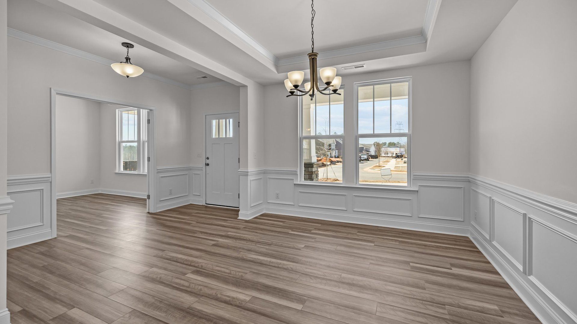 Ample and inviting entrance, dining room, and study, with premium finishes, in the Norris Design by DRB Homes in York, SC