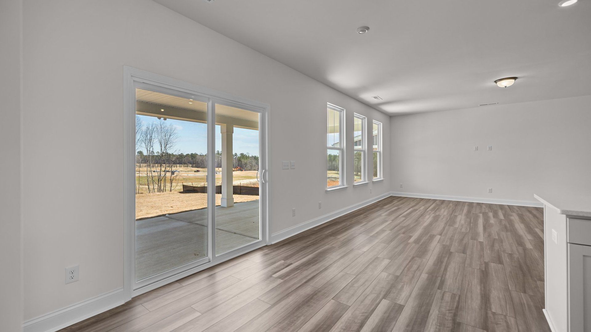 Eat-in breakfast area and family room with access to the expansive covered porch, in the Norris Design by DRB Homes, York, SC