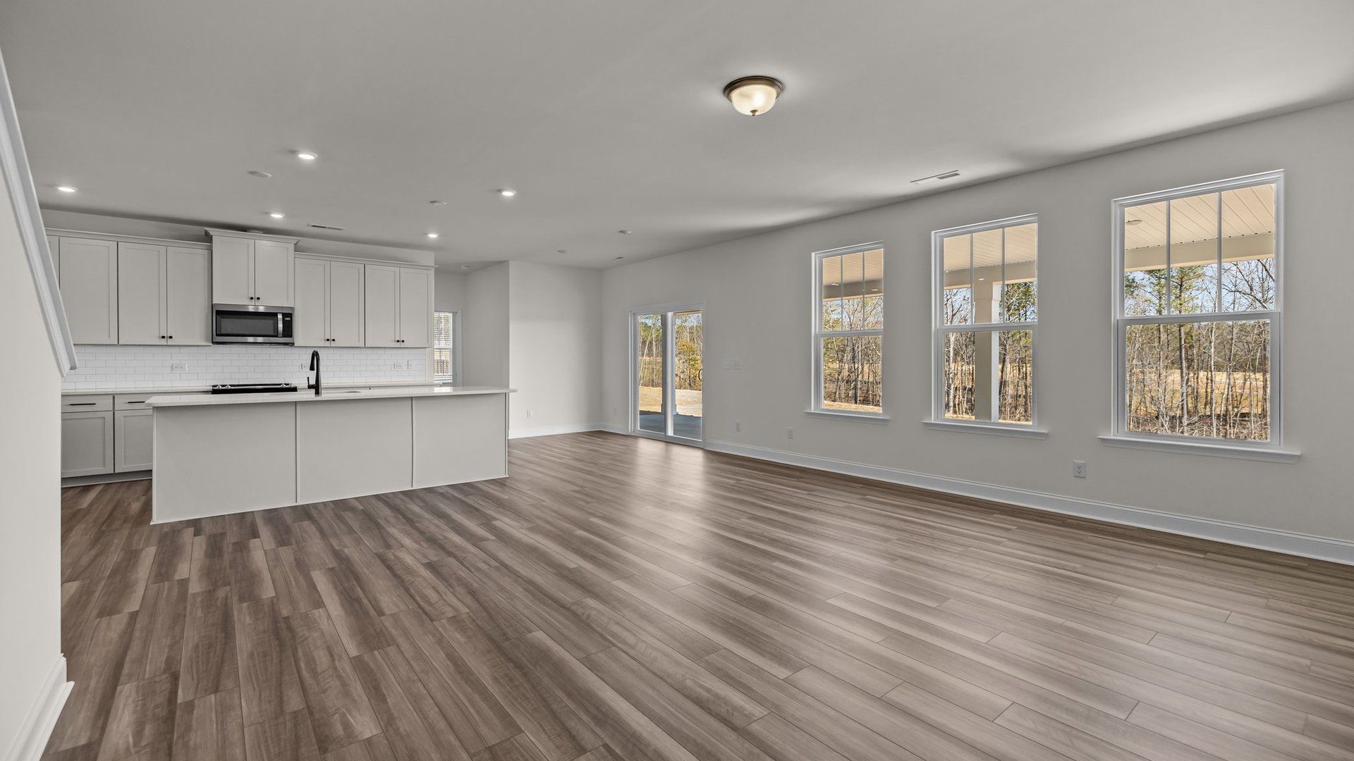 Spacious and bright open concept with large windows and elevated ceiling in the Norris Design by DRB Homes in York, SC
