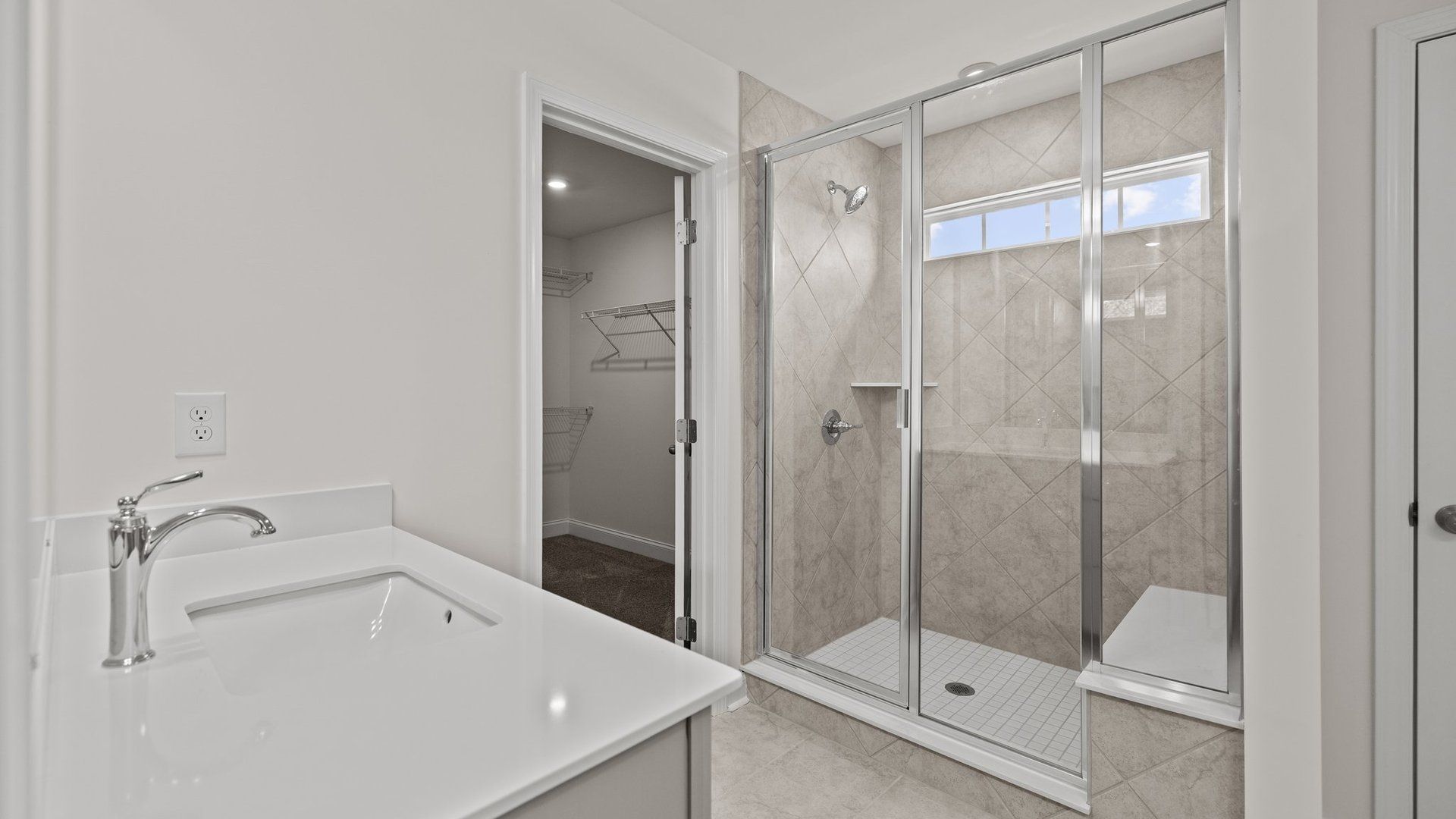 Modern bathroom with fully tiled walk-in shower and seat, in the Norris Design by DRB Homes at Lakeside Glen in York, SC