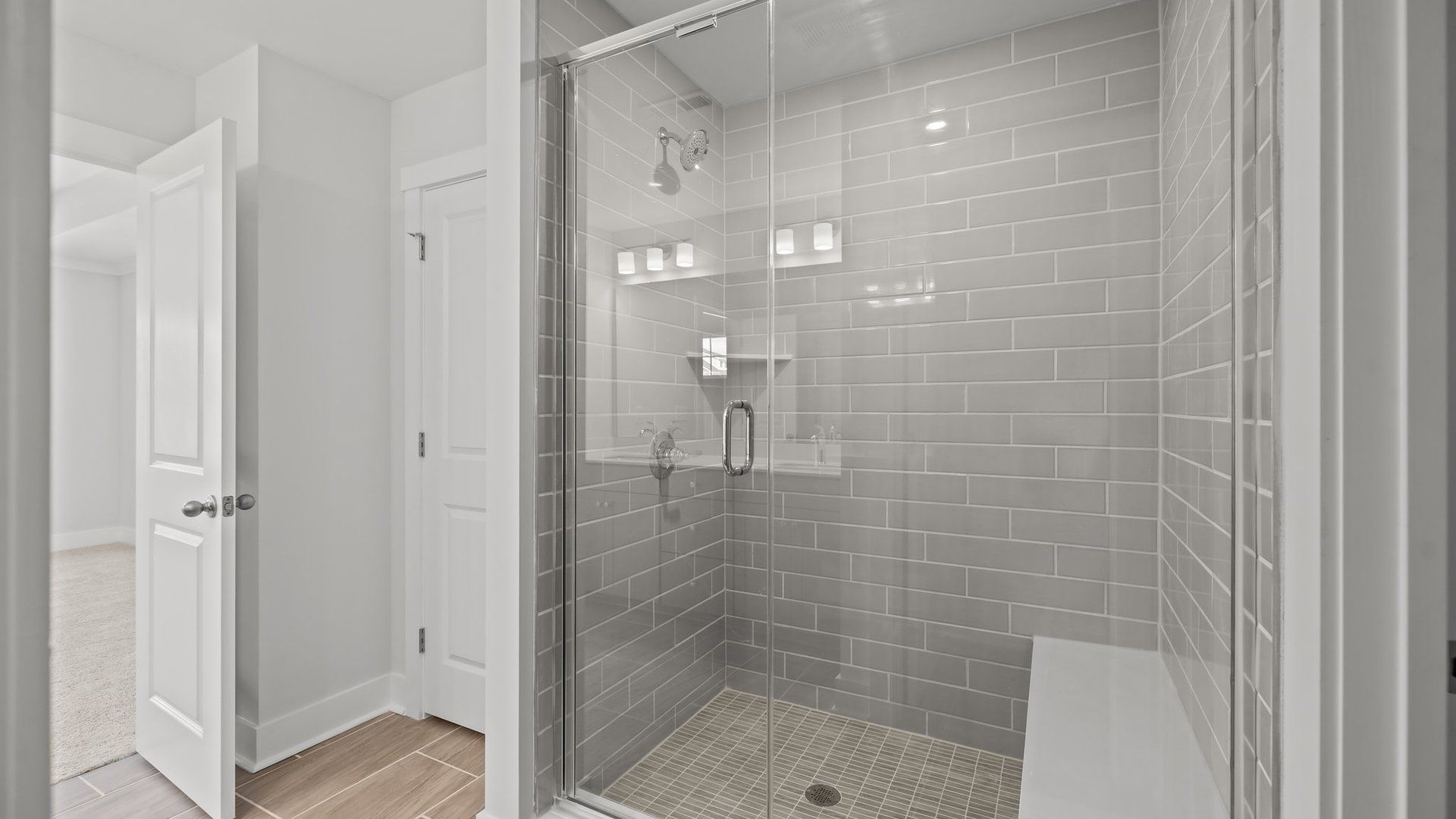 Burton Design fully-tiled shower with seat and premium finishes. At Lakeside Glen by DRB Homes in York, SC.
