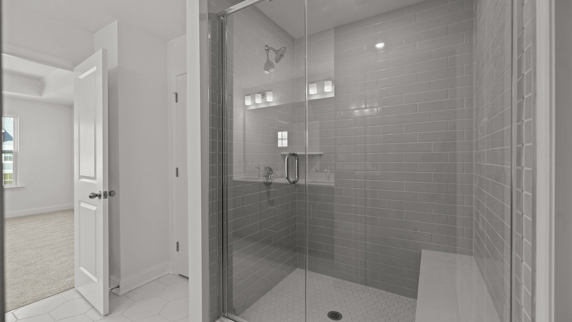Burton Design fully tiled shower with seat and premium finishes. At Lakeside Glen by DRB Homes in York, SC.