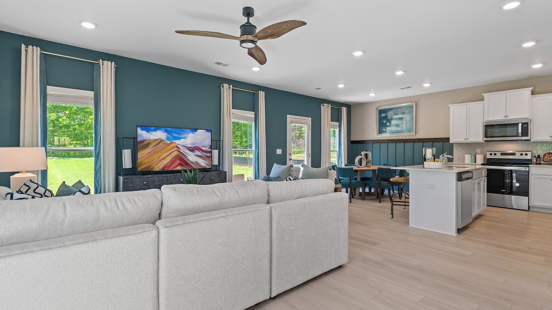 Reagan open floor plan with connected family room, kitchen and breakfast area at Abbotts Crossing in Conyers, GA.