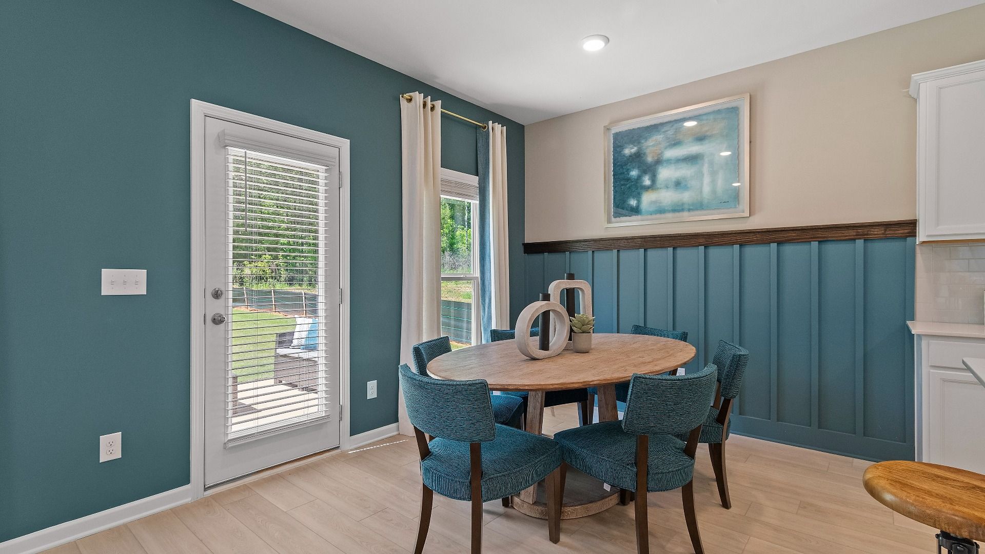 Airy breakfast area with natural light and view into back patio and yard area at Abbotts Crossing in Conyers, GA.