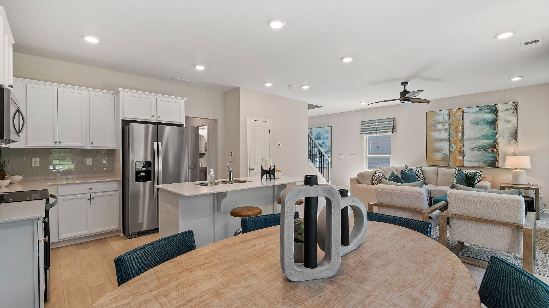 Open concept Reagan floorplan featuring a kitchen with a center island looking into the family room at Abbotts Crossing.