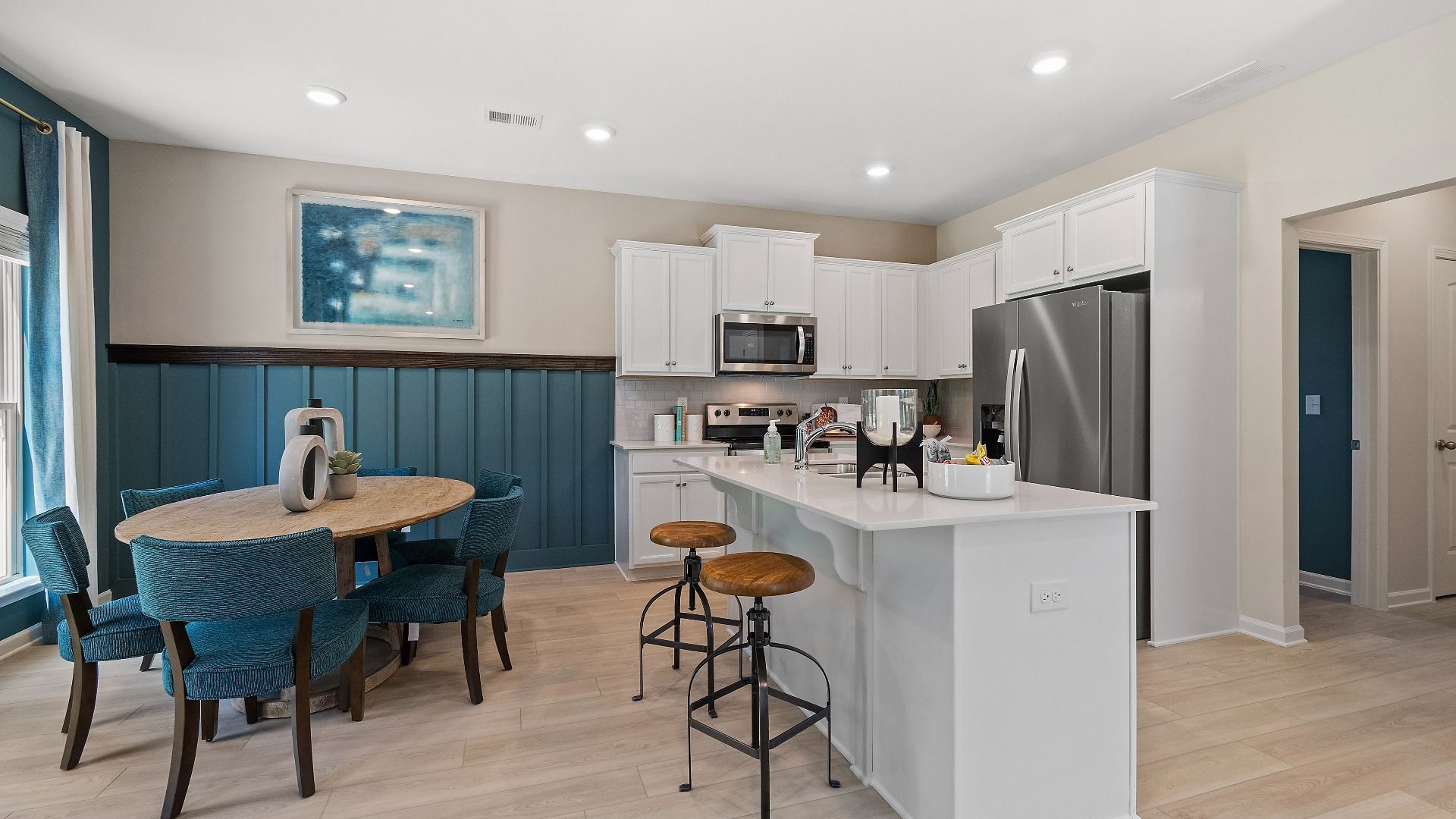 Reagan kitchen with bright features including center island and white cabinetry at Abbotts Crossing in Conyers, GA.