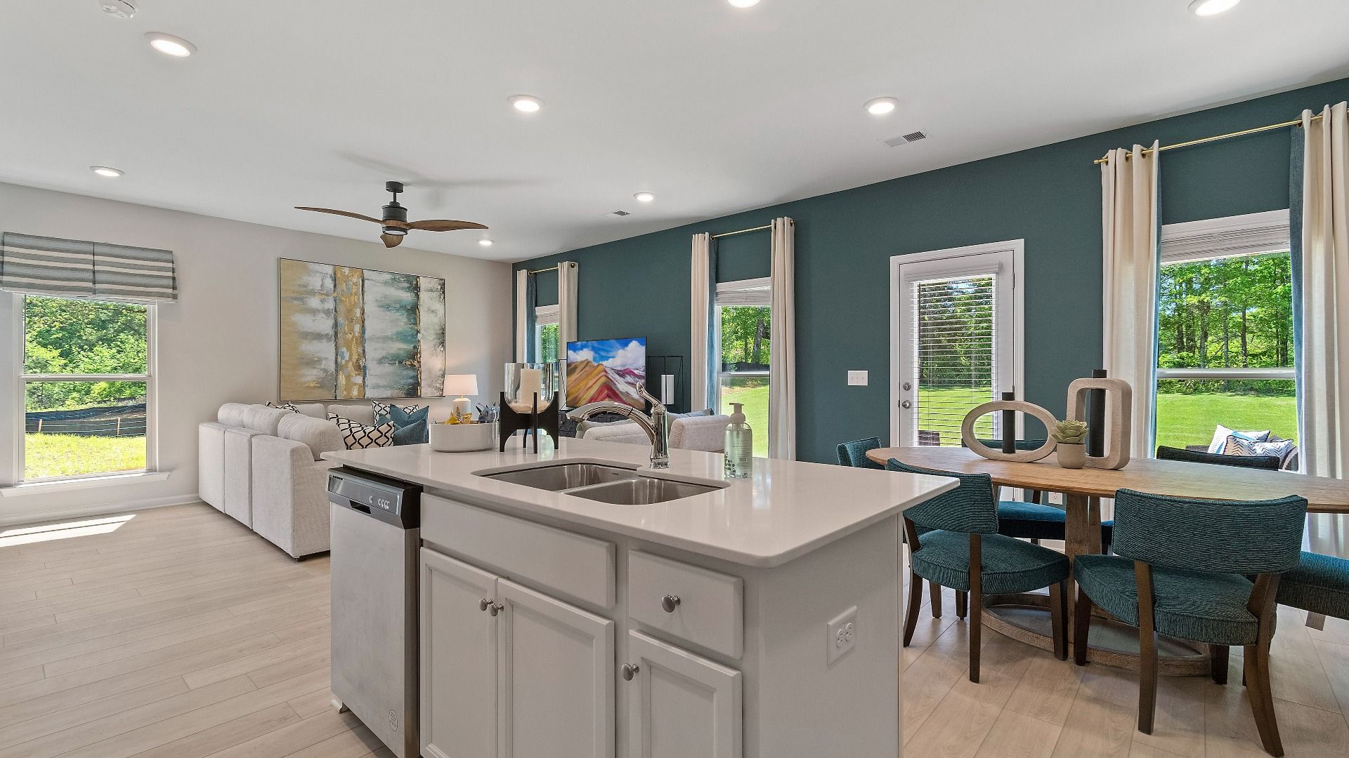 Center island with view into family room and breakfast area in Reagan floorplan at Abbotts Crossing.