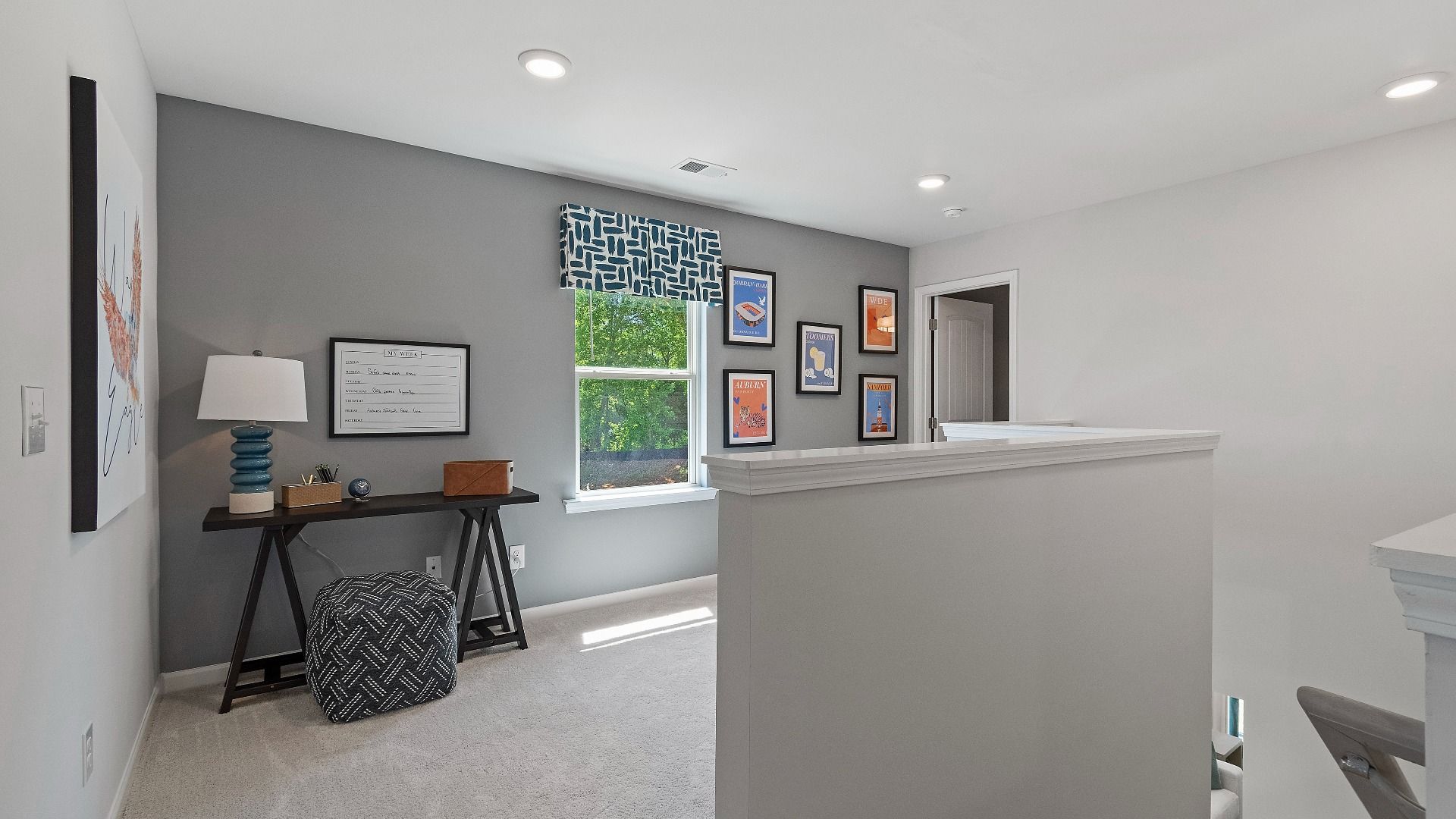 Upstairs loft area with carpet flooring and natural light in Reagan floorplan at Abbotts Crossing.