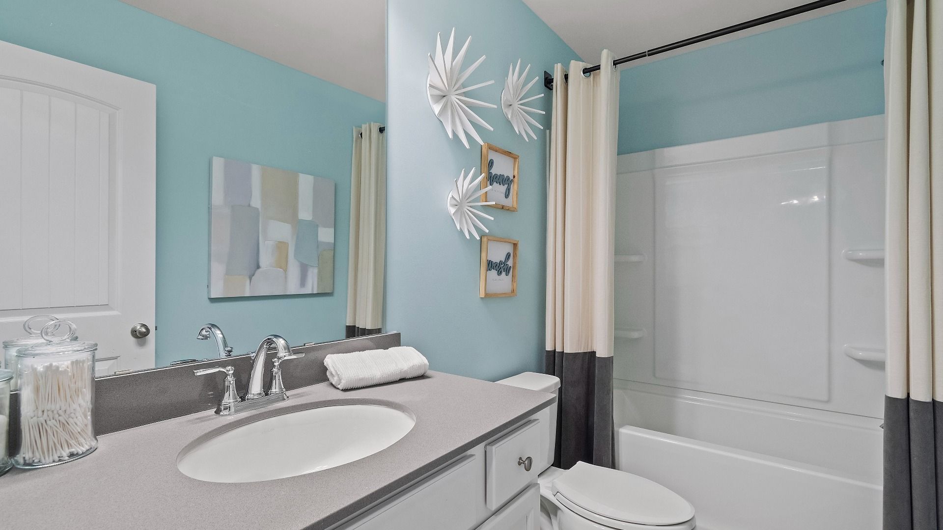 Reagan full bath with tub shower and spacious vanity at Abbotts Crossing in Conyers, GA.