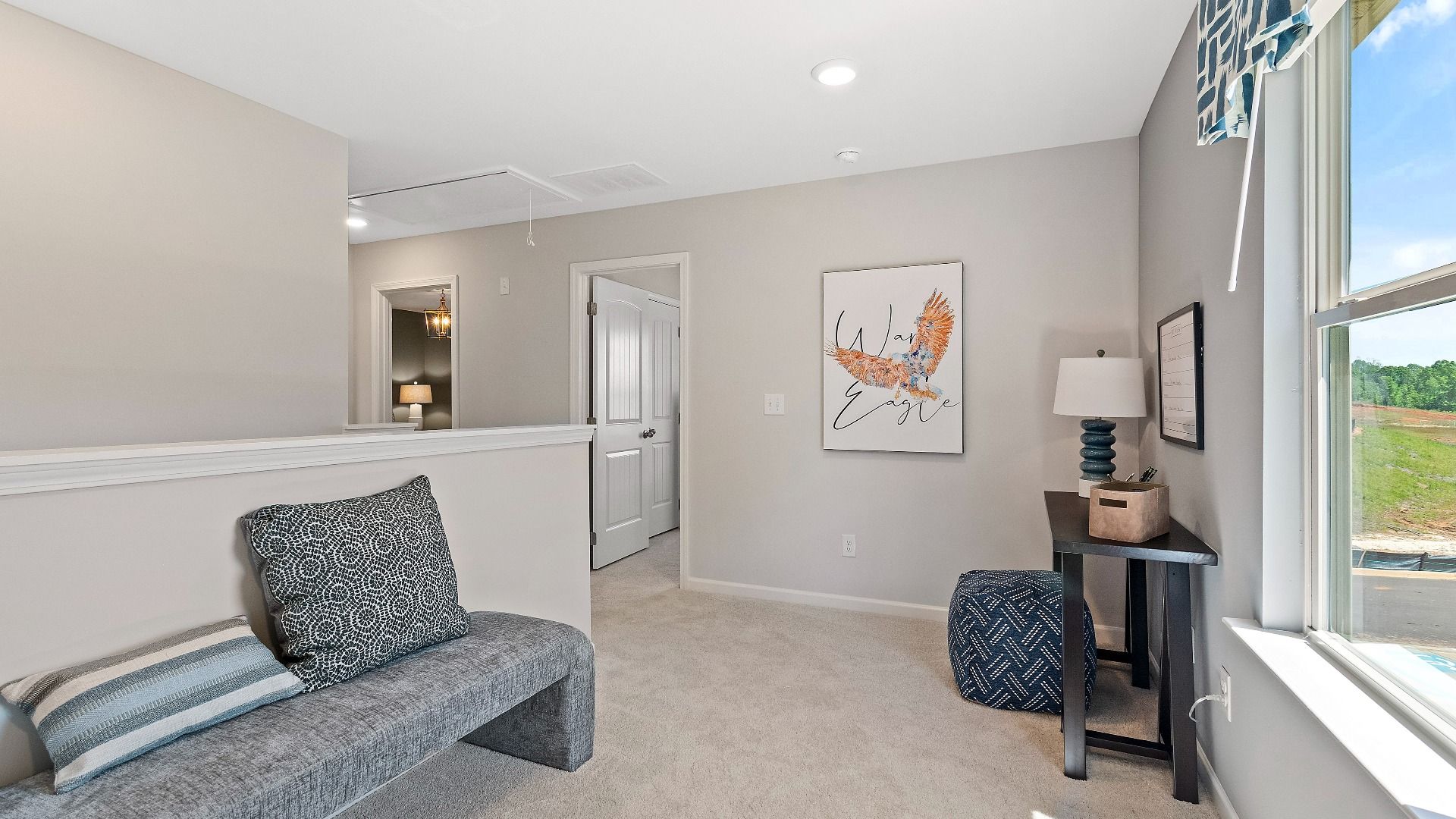 Reagan loft area with comfortable seating space and bright natural light at Abbotts Crossing.