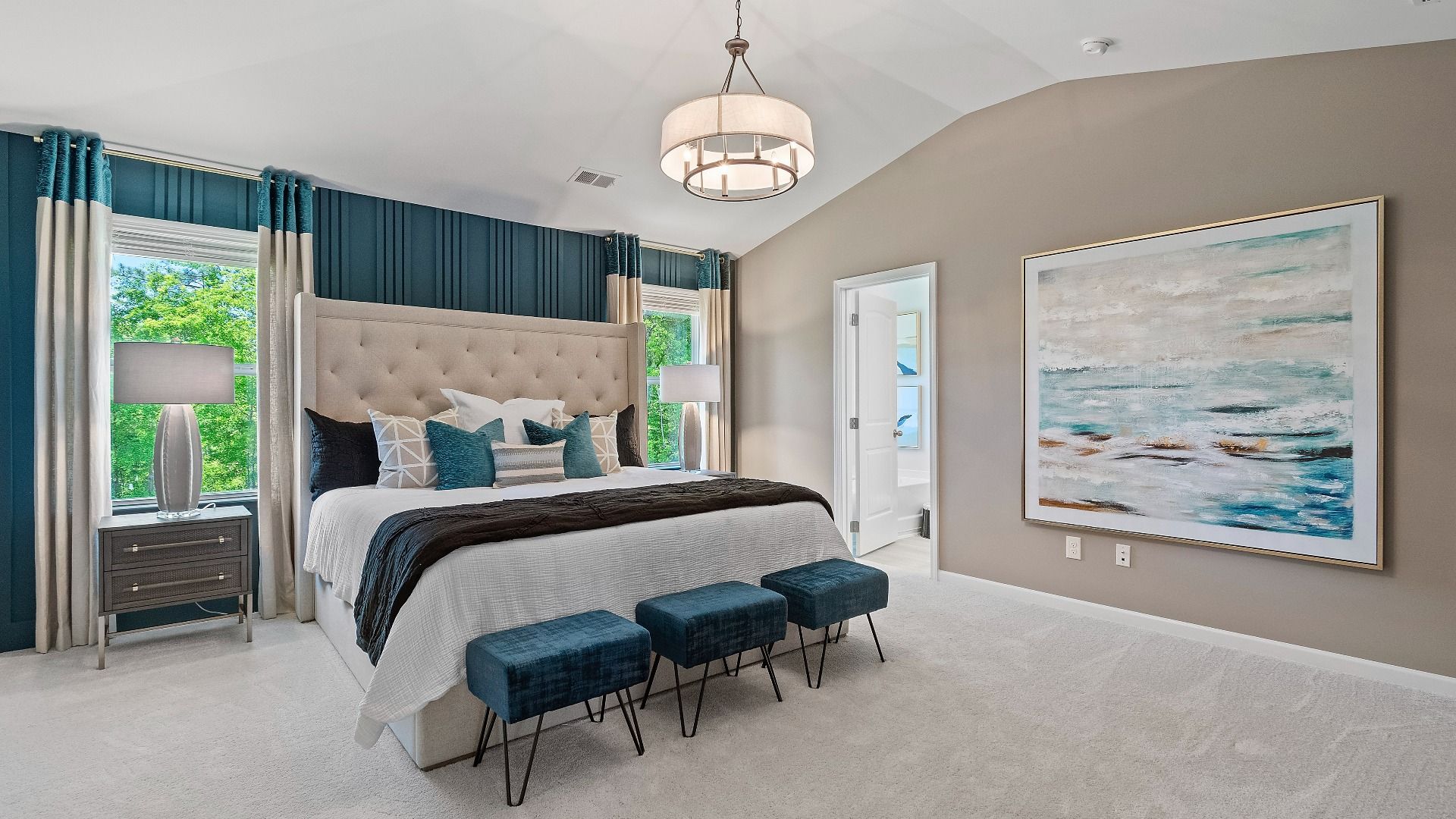 Reagan primary suite with carpet flooring, large windows, and neutral color palette at Abbotts Crossing.