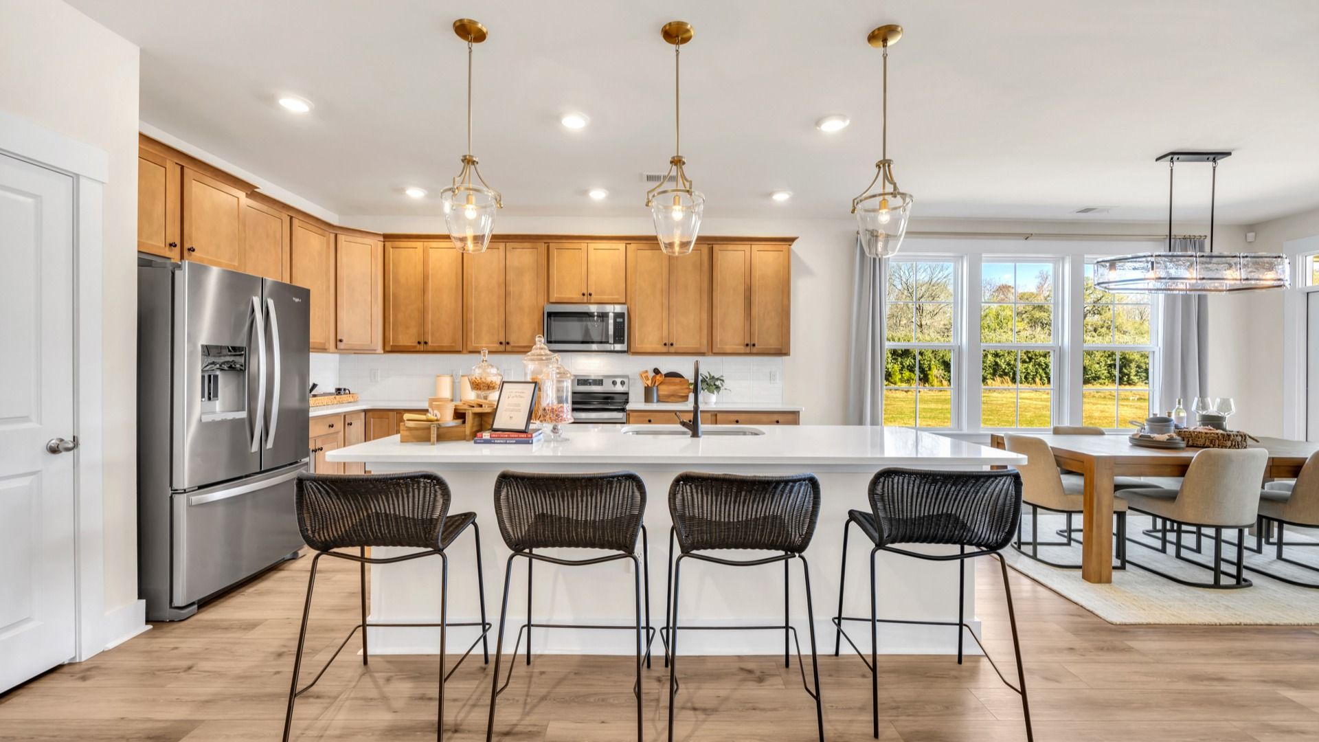 Kitchen in Chestnut Farms in by DRB homes offering an open layout with a kitchen island and amazing light fixtures